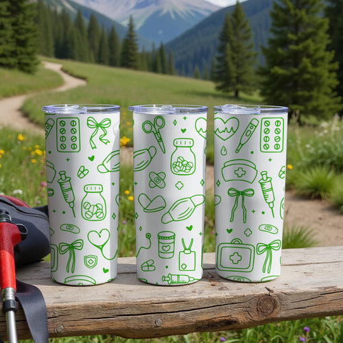 Three white tumblers with green medical icons on a wooden surface.