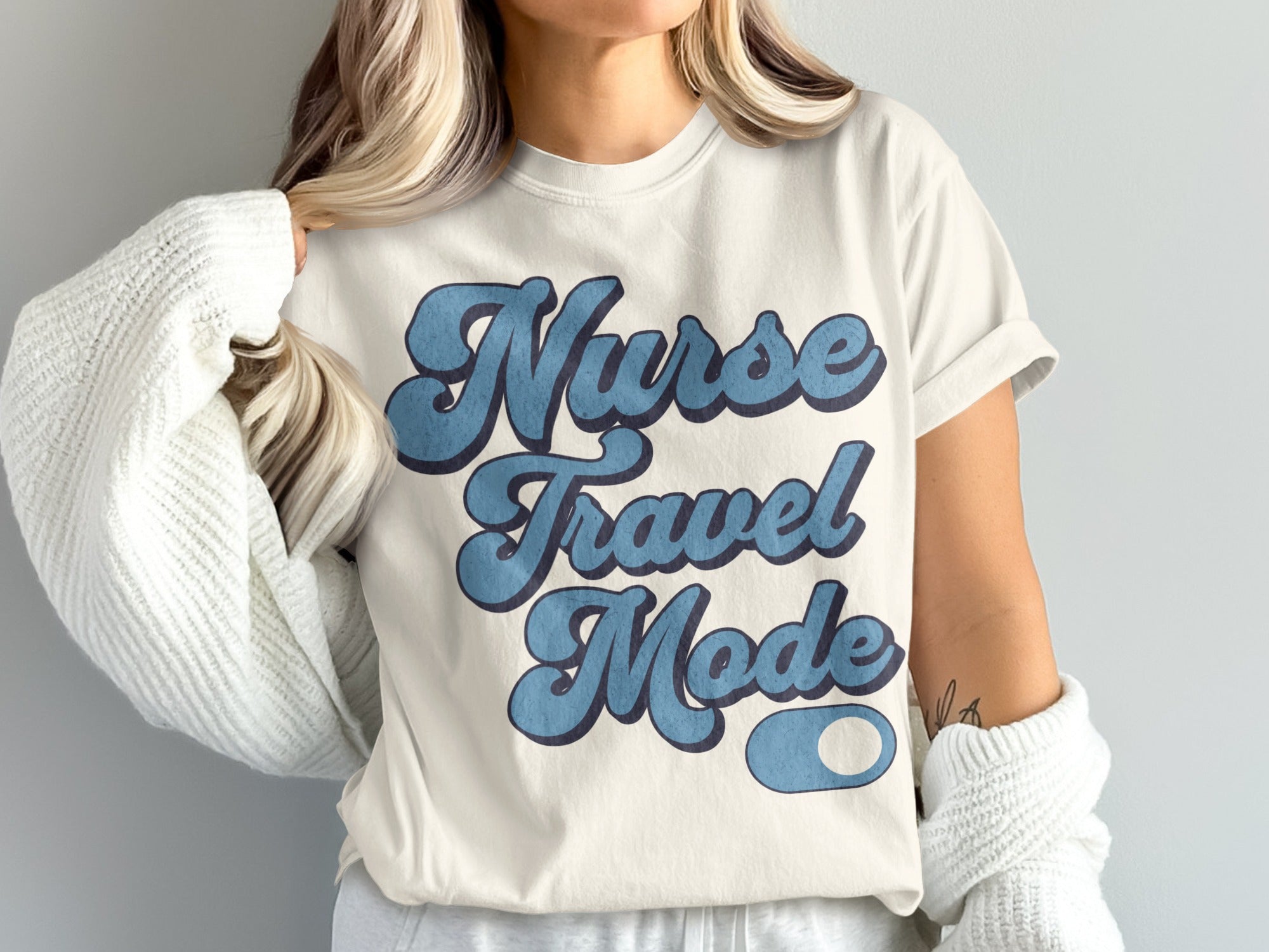 Cream t-shirt with blue retro text "Nurse Travel Mode"