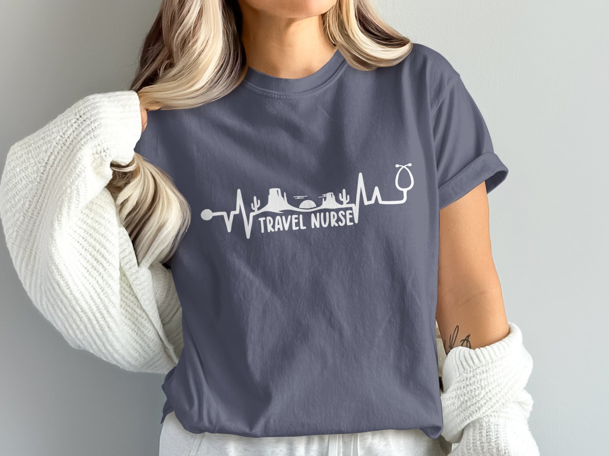 Dark grey t-shirt with white "Travel Nurse" text and heartbeat graphic.
