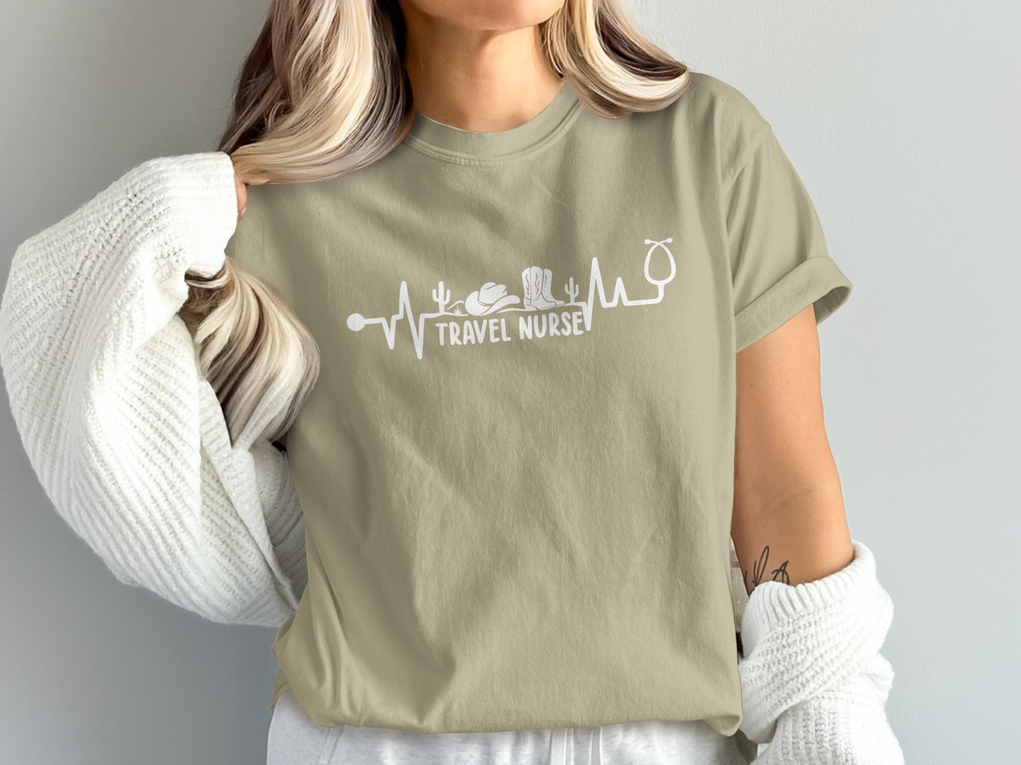 Tan t-shirt with "Travel Nurse" text and stethoscope, cactus, and cowboy boot graphics.
