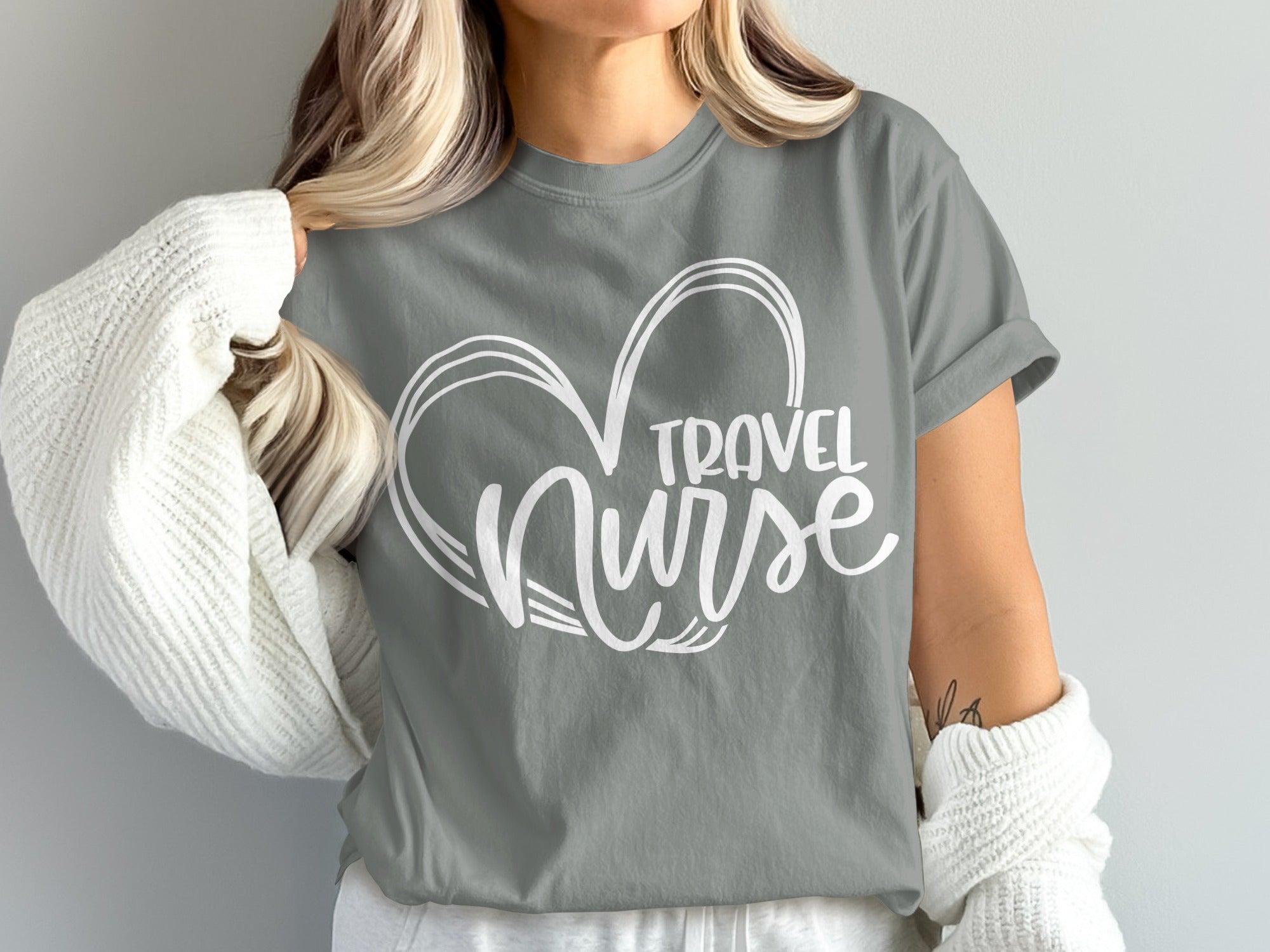 Grey t-shirt with "TRAVEL NURSE" text inside a white heart design.