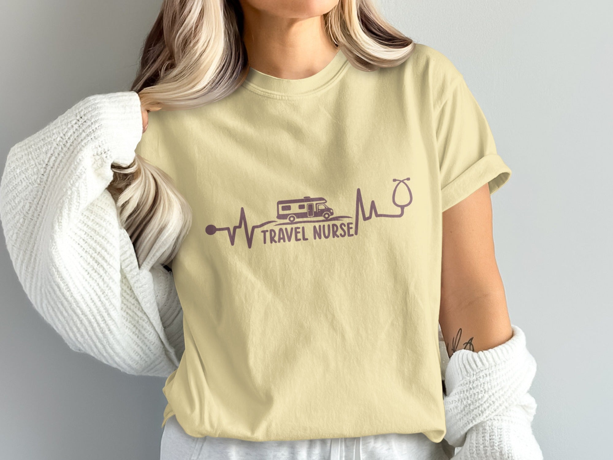 Light yellow t-shirt with "Travel Nurse" text and heartbeat graphic with RV and stethoscope.