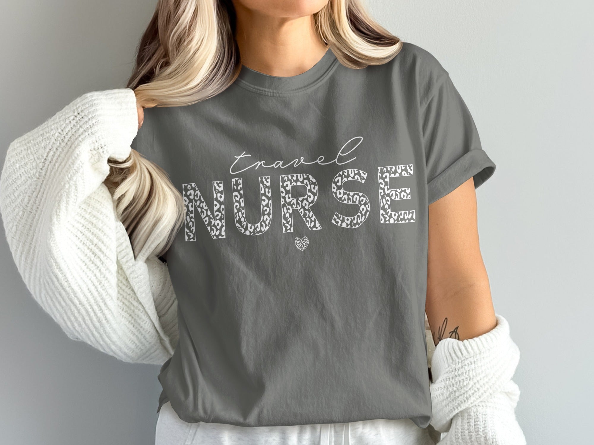 Travel Nurse text with leopard print fill on a dark grey t-shirt.