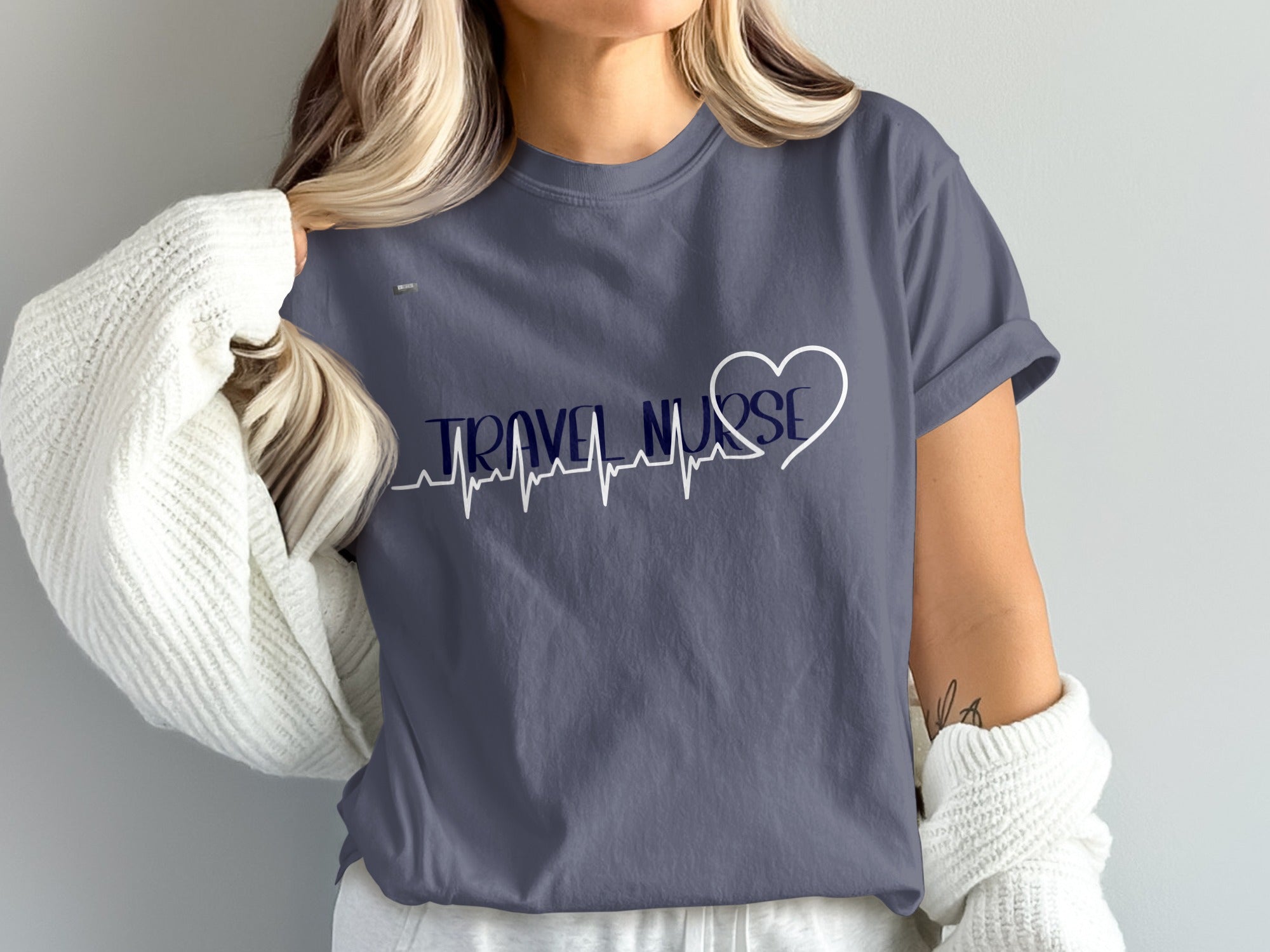 Dark grey t-shirt with white and navy "Travel Nurse" text and heartbeat line.