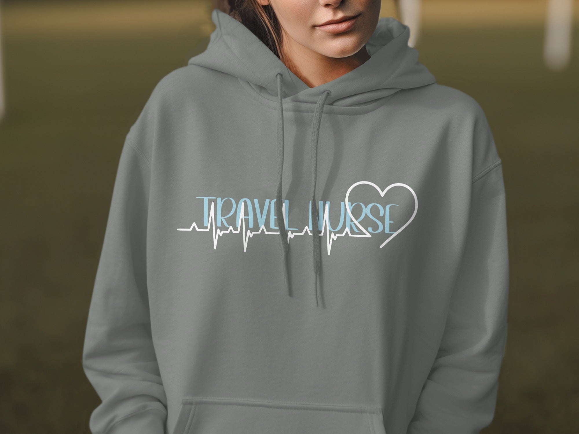 Grey hoodie with "Travel Nurse" text and a heart-shaped ECG line.
