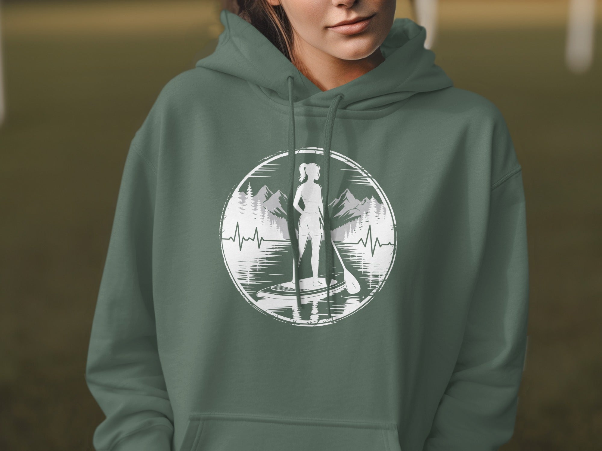 Green hoodie with circular graphic of paddleboarder, mountains, and heartbeat.
