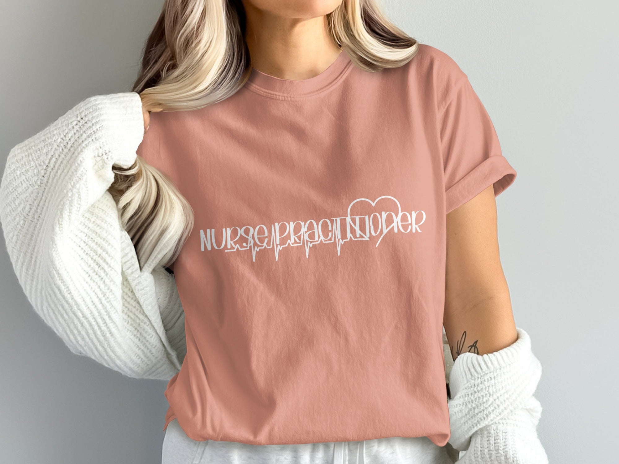 Salmon t-shirt with white "Nurse Practitioner" text and heart rate line.