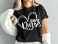 Black t-shirt with white heart graphic and "Travel Nurse" text.
