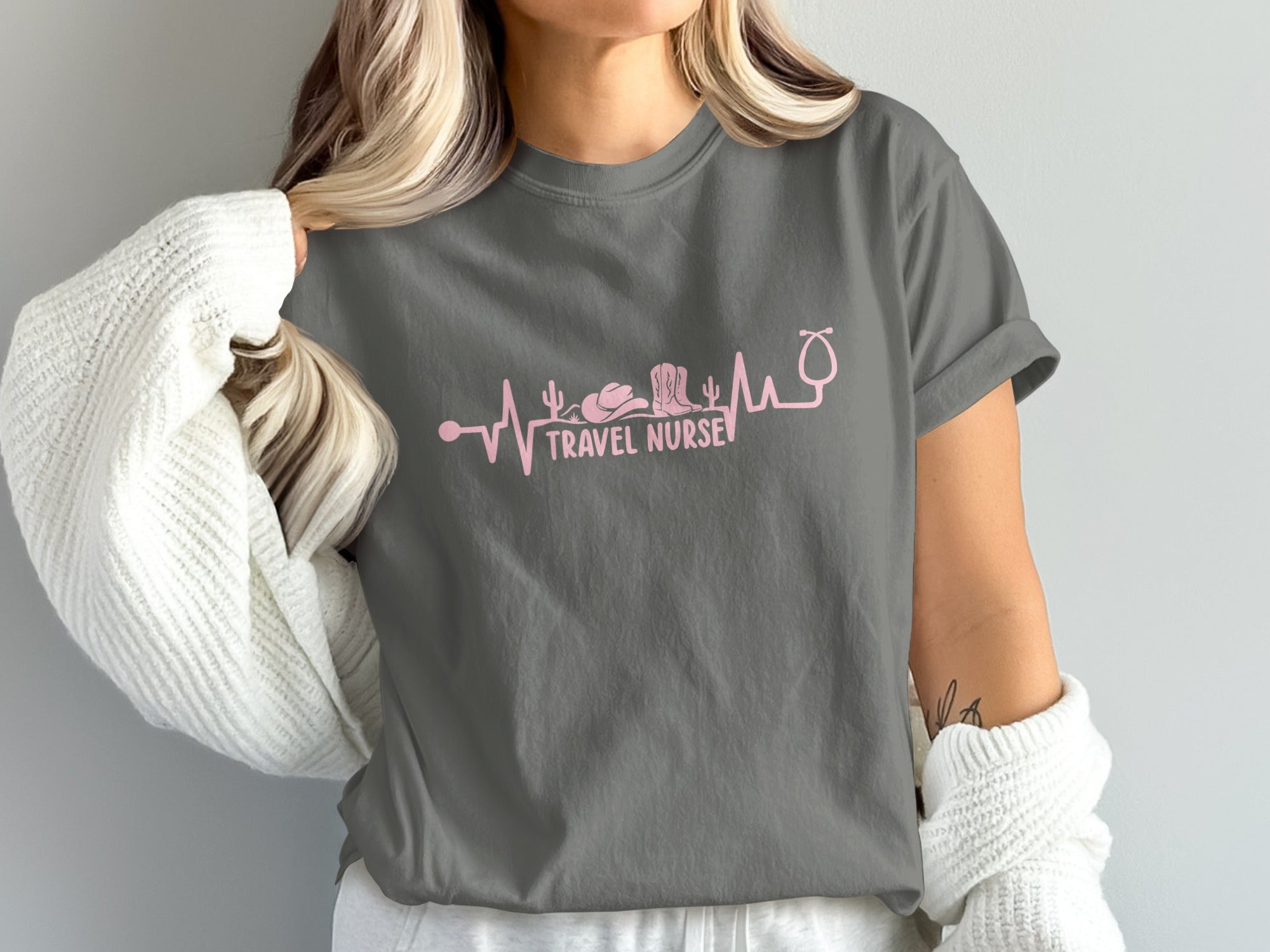 Gray t-shirt with pink heartbeat design featuring a stethoscope, cowboy boot, and cactus.