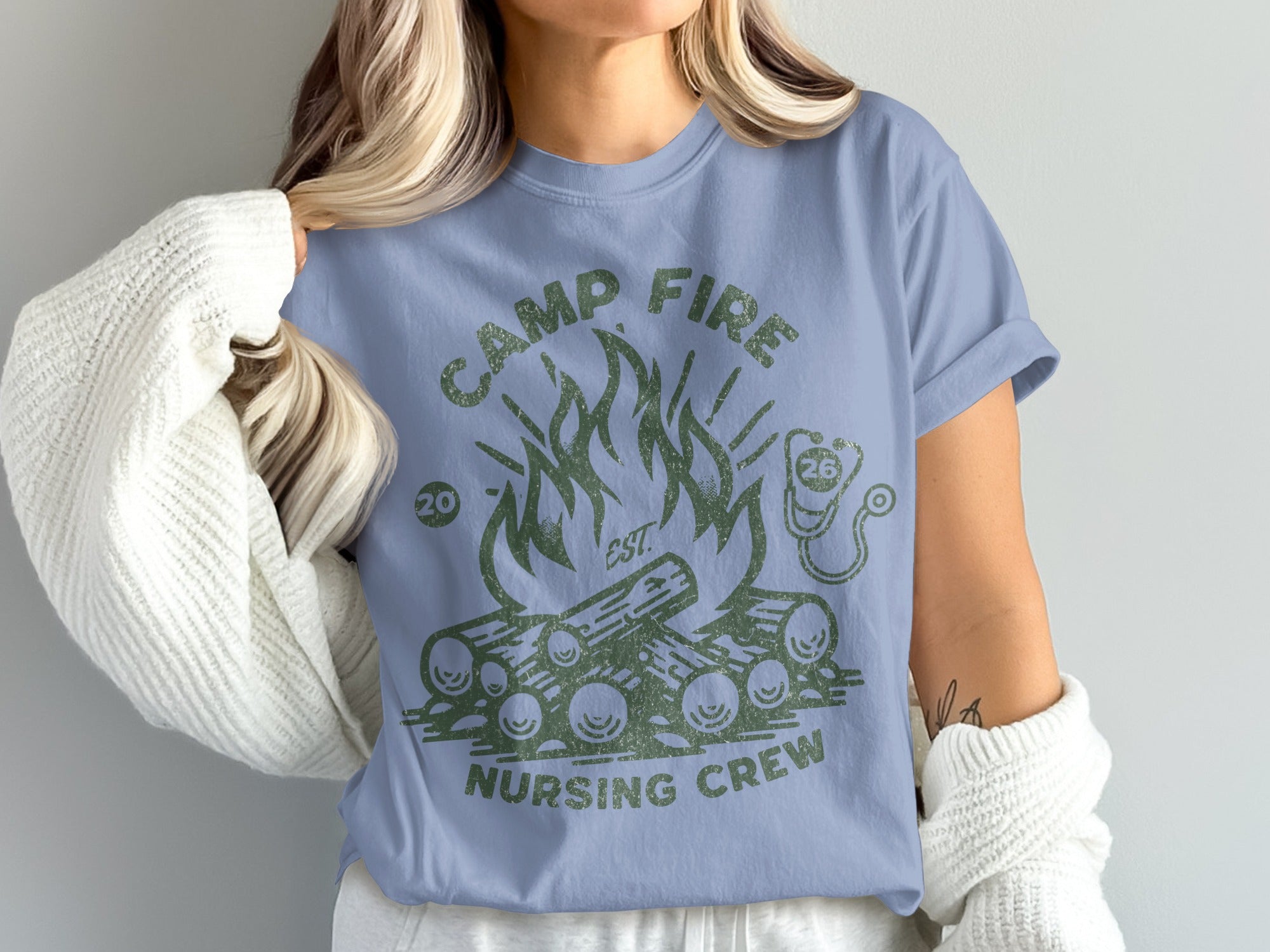 Camp Fire Nursing Crew distressed graphic on a light blue t-shirt.