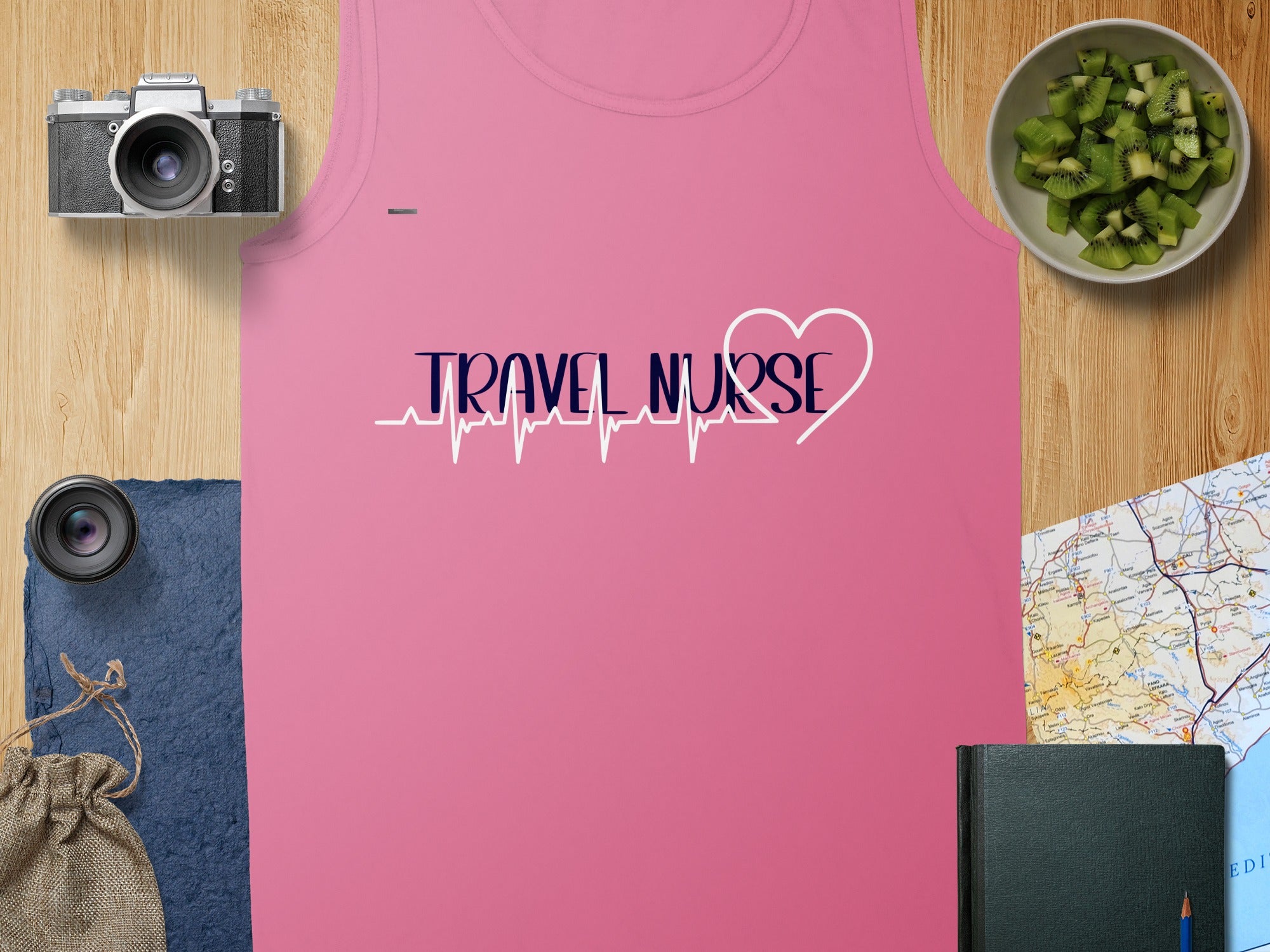 Pink tank top with "Travel Nurse" text and a heartbeat line, plus travel items.