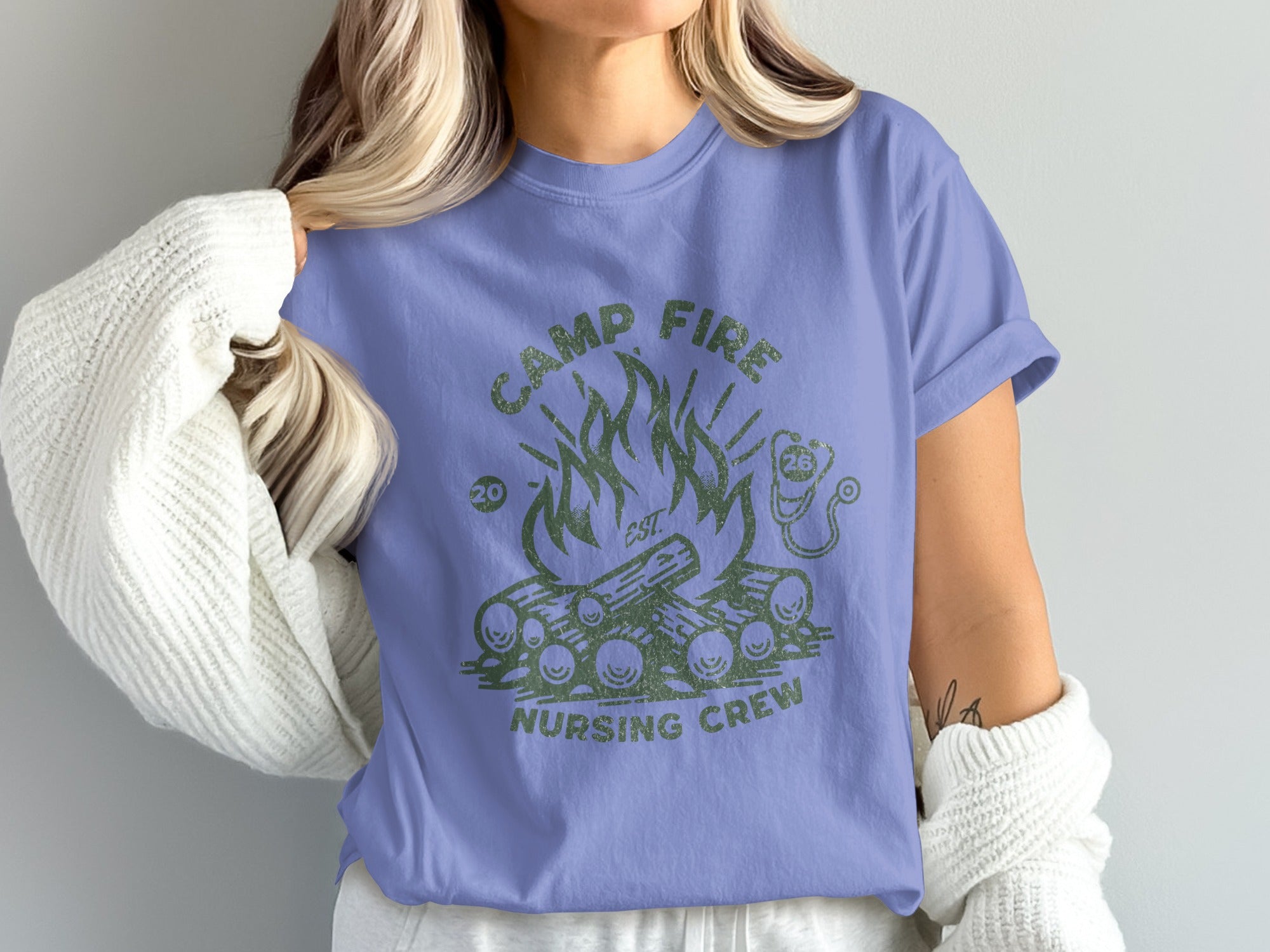 Camp Fire Nursing Crew graphic tee on a woman wearing a white cardigan.