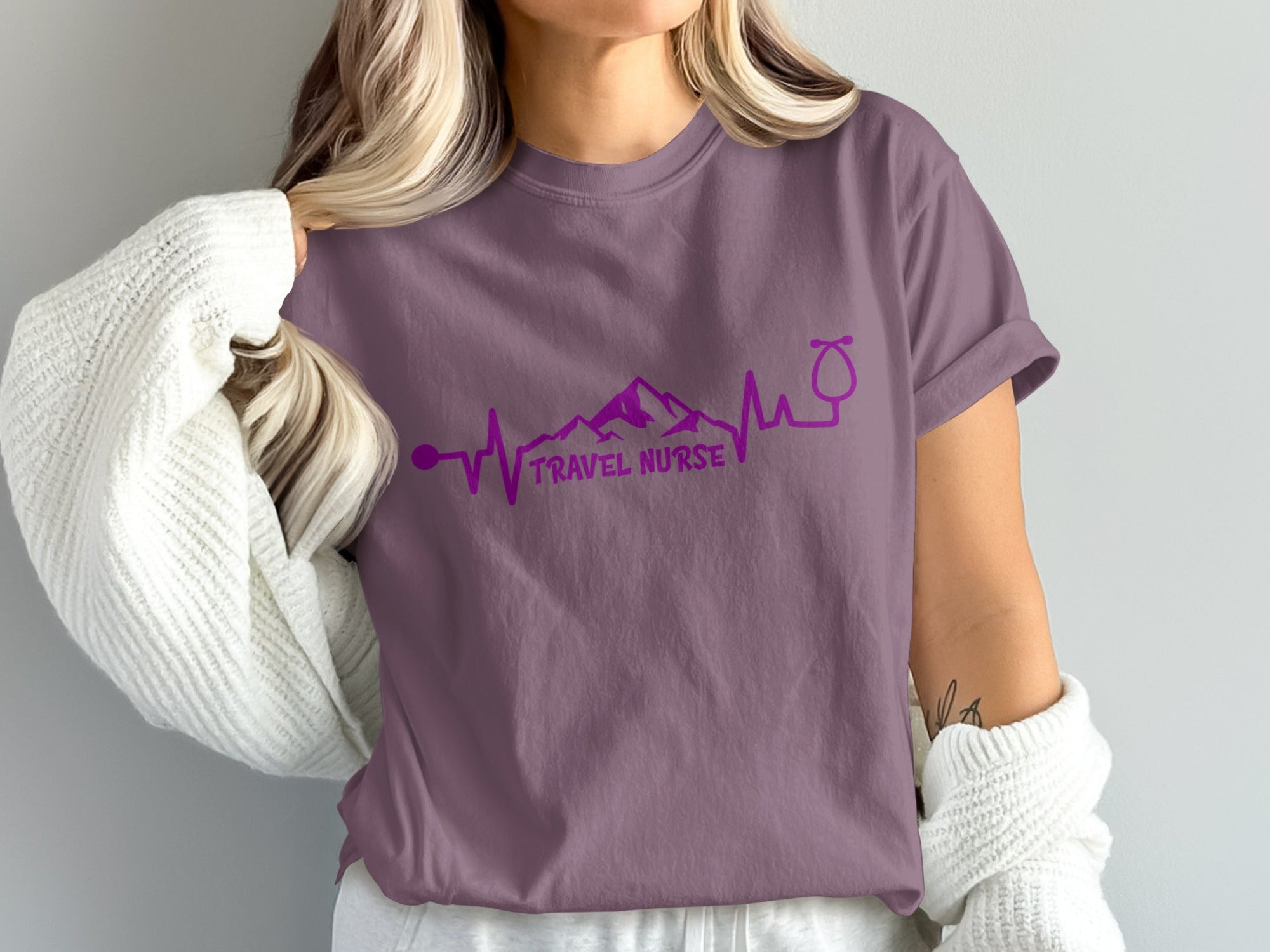 Purple t-shirt with "TRAVEL NURSE" and mountain heartbeat stethoscope graphic.