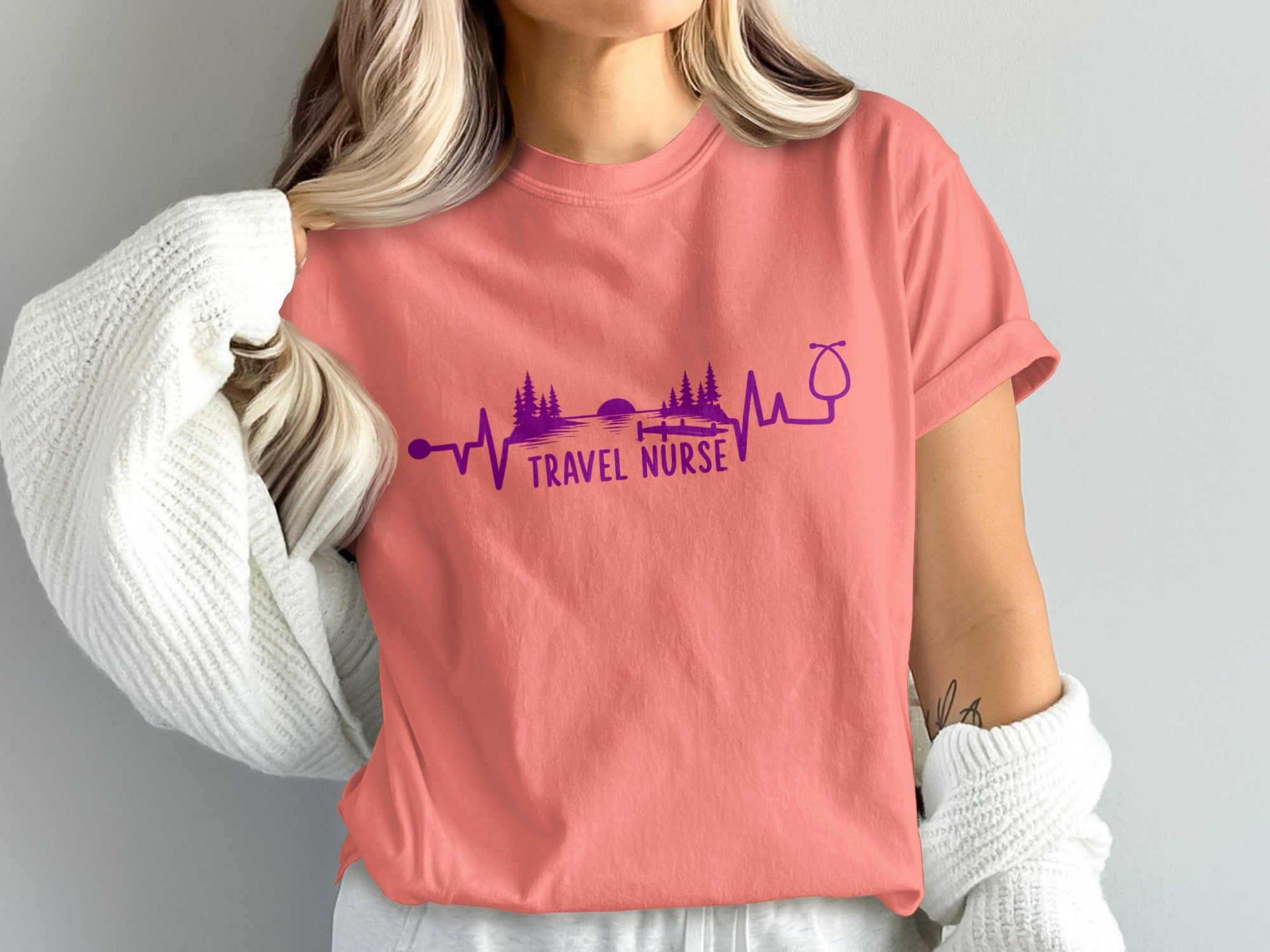 Coral t-shirt with "Travel Nurse" text and electrocardiogram design.