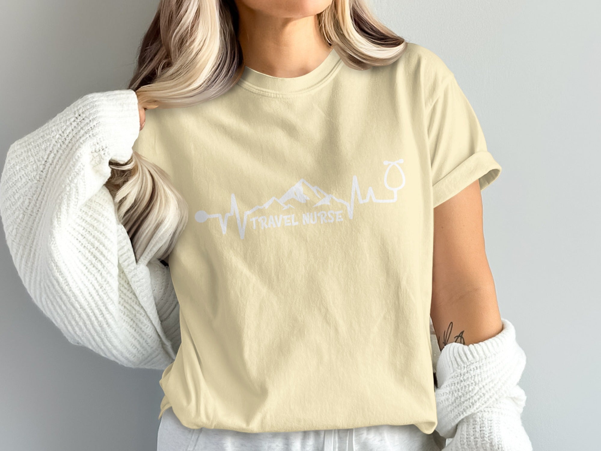 Light yellow t-shirt with "TRAVEL NURSE" and mountain-stethoscope design.