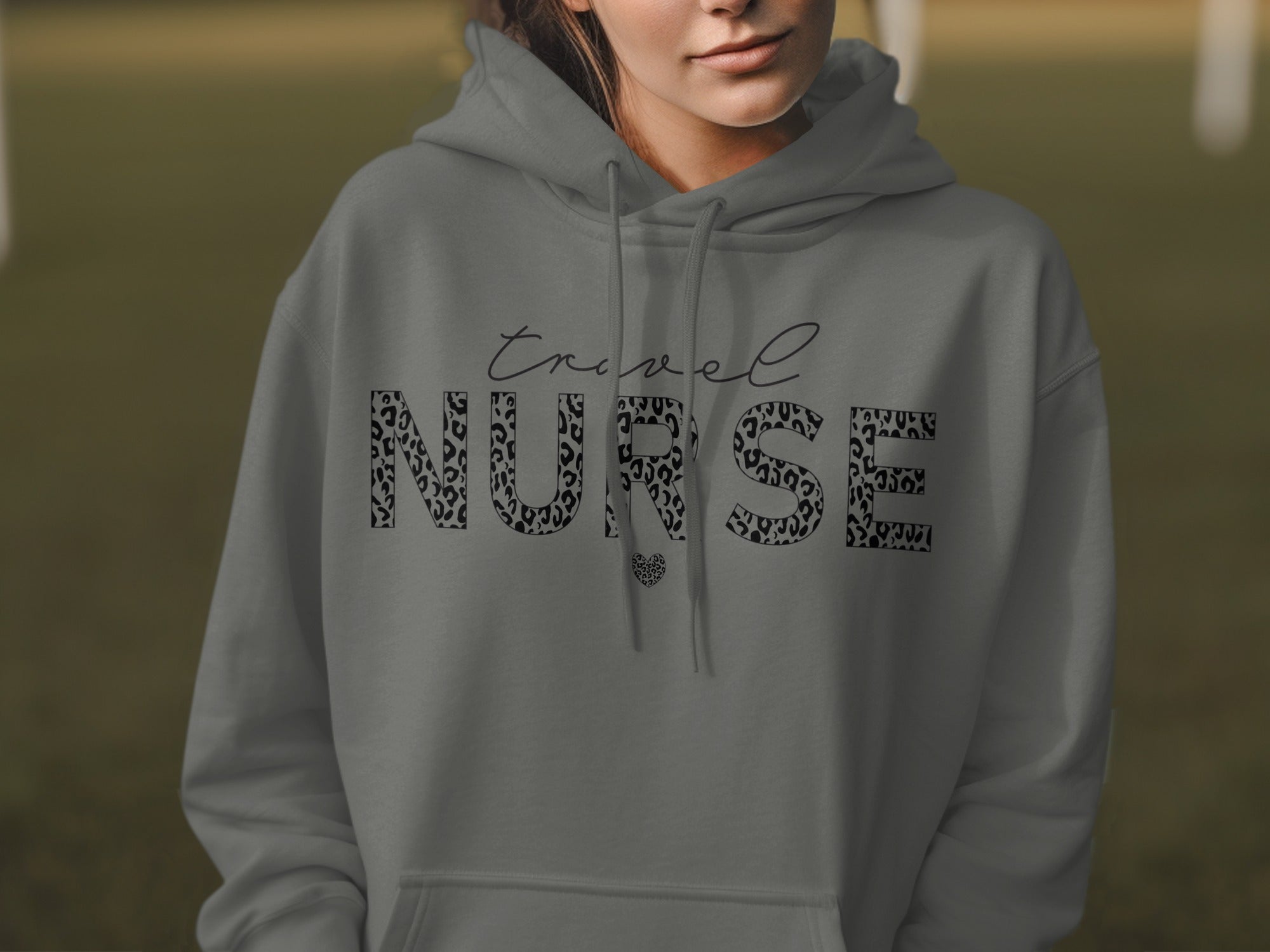 Grey hoodie with "Travel Nurse" text in a leopard print font.