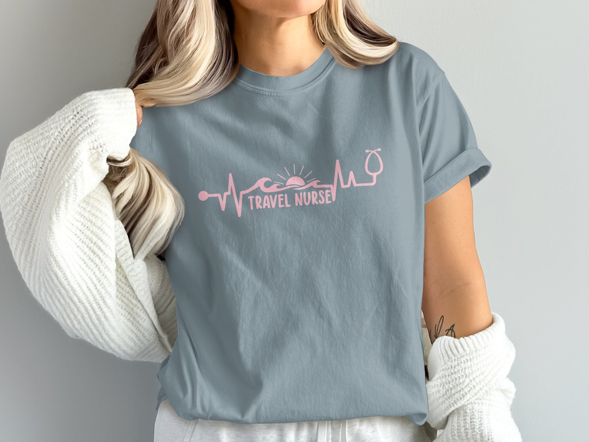 Gray t-shirt with pink heartbeat, waves, sun, and stethoscope graphic.