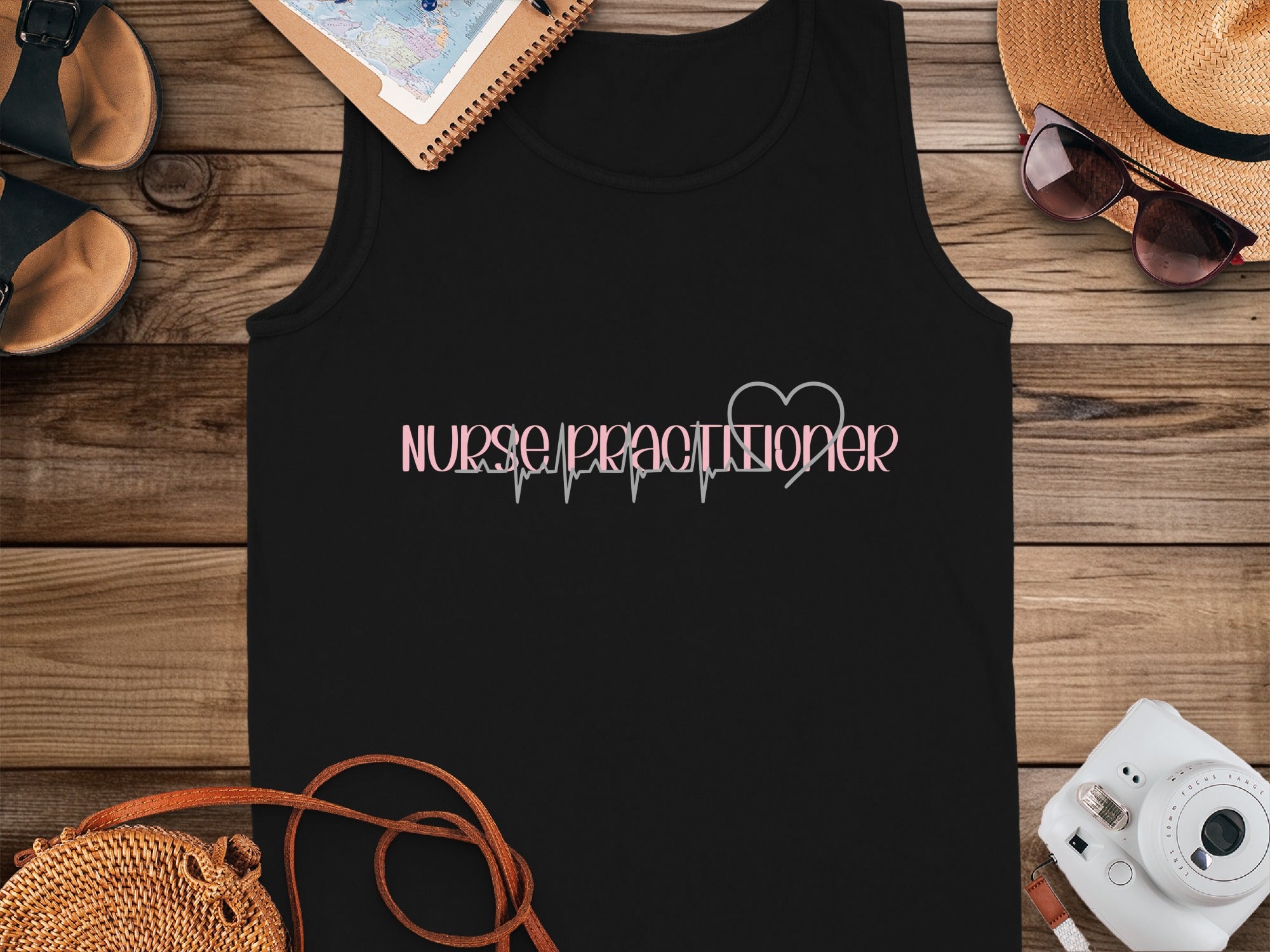 Black tank top with "Nurse Practitioner" in pink cursive and a heartbeat line.