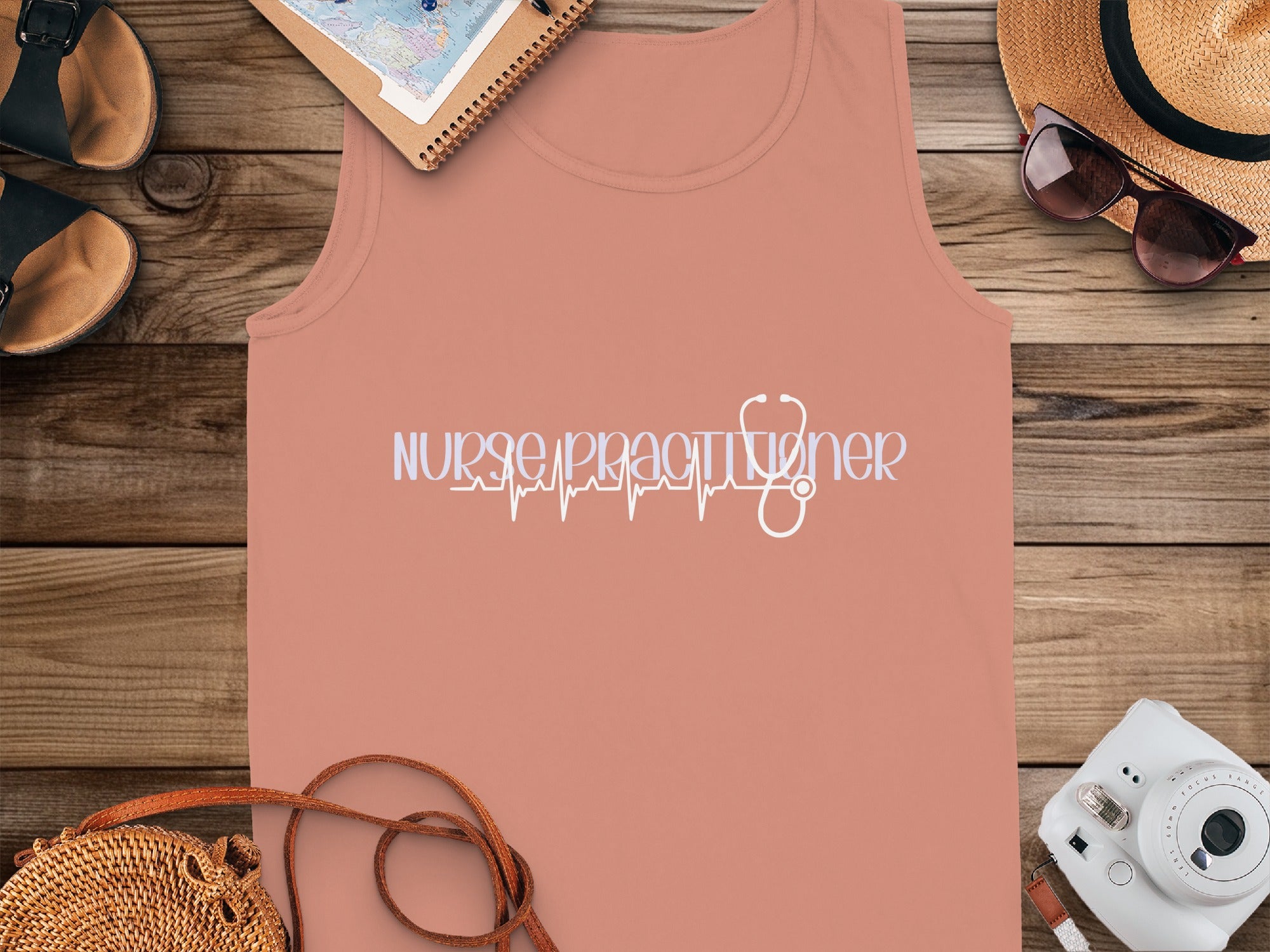 Nurse Practitioner text with stethoscope heart monitor graphic on coral tank top.