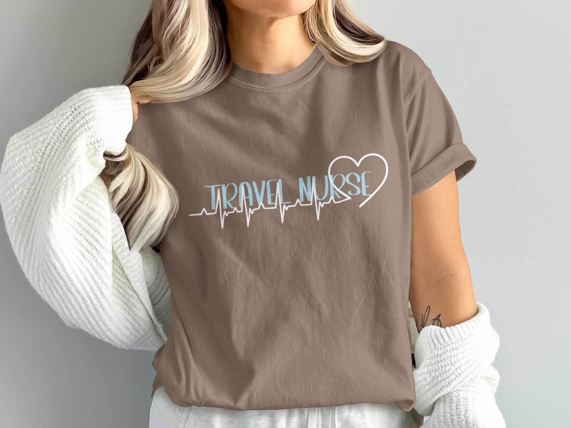 Brown t-shirt with "Travel Nurse" and heart EKG graphic.