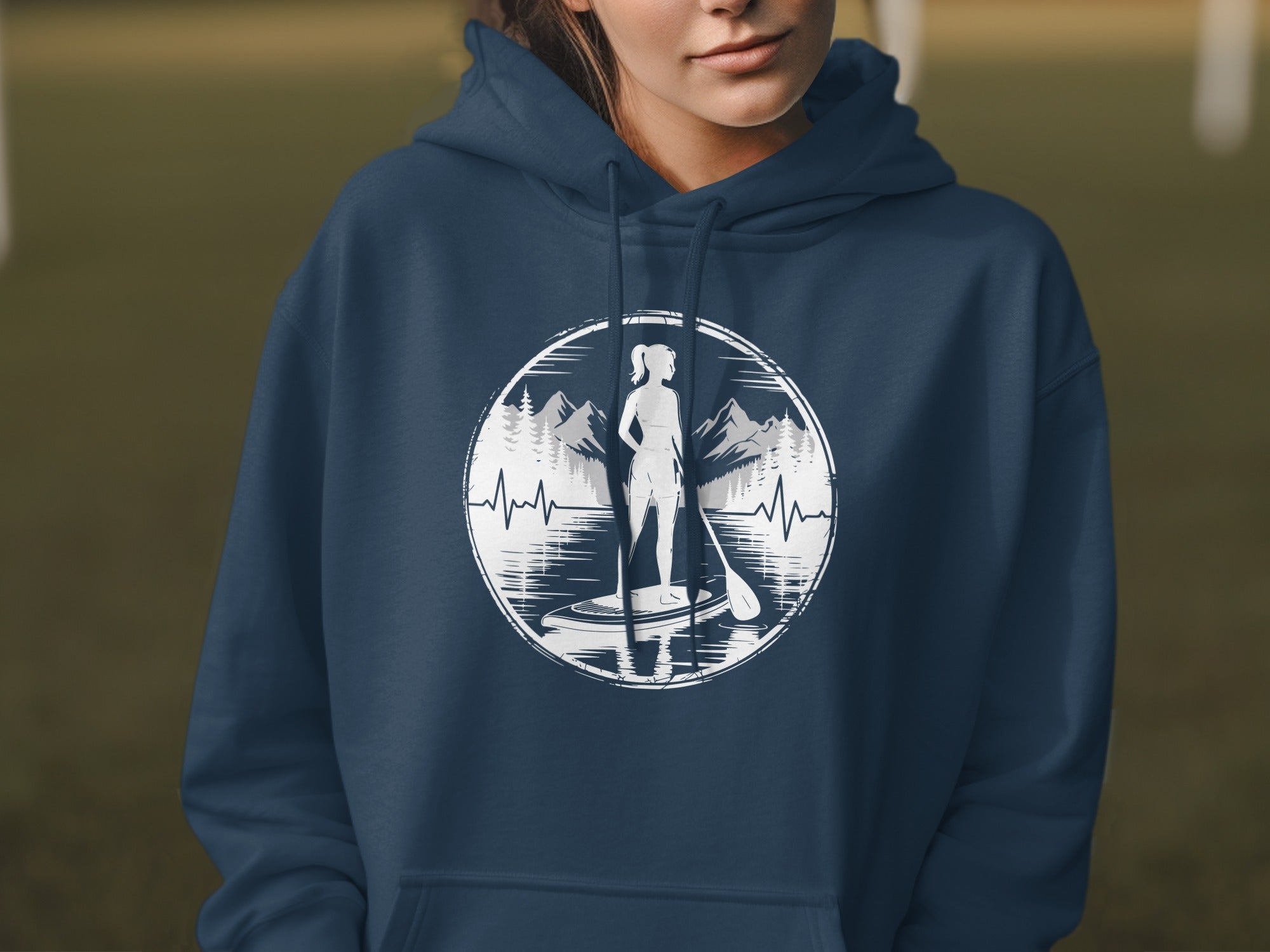 Navy hoodie with white graphic of woman paddleboarding with mountains and heartbeat.