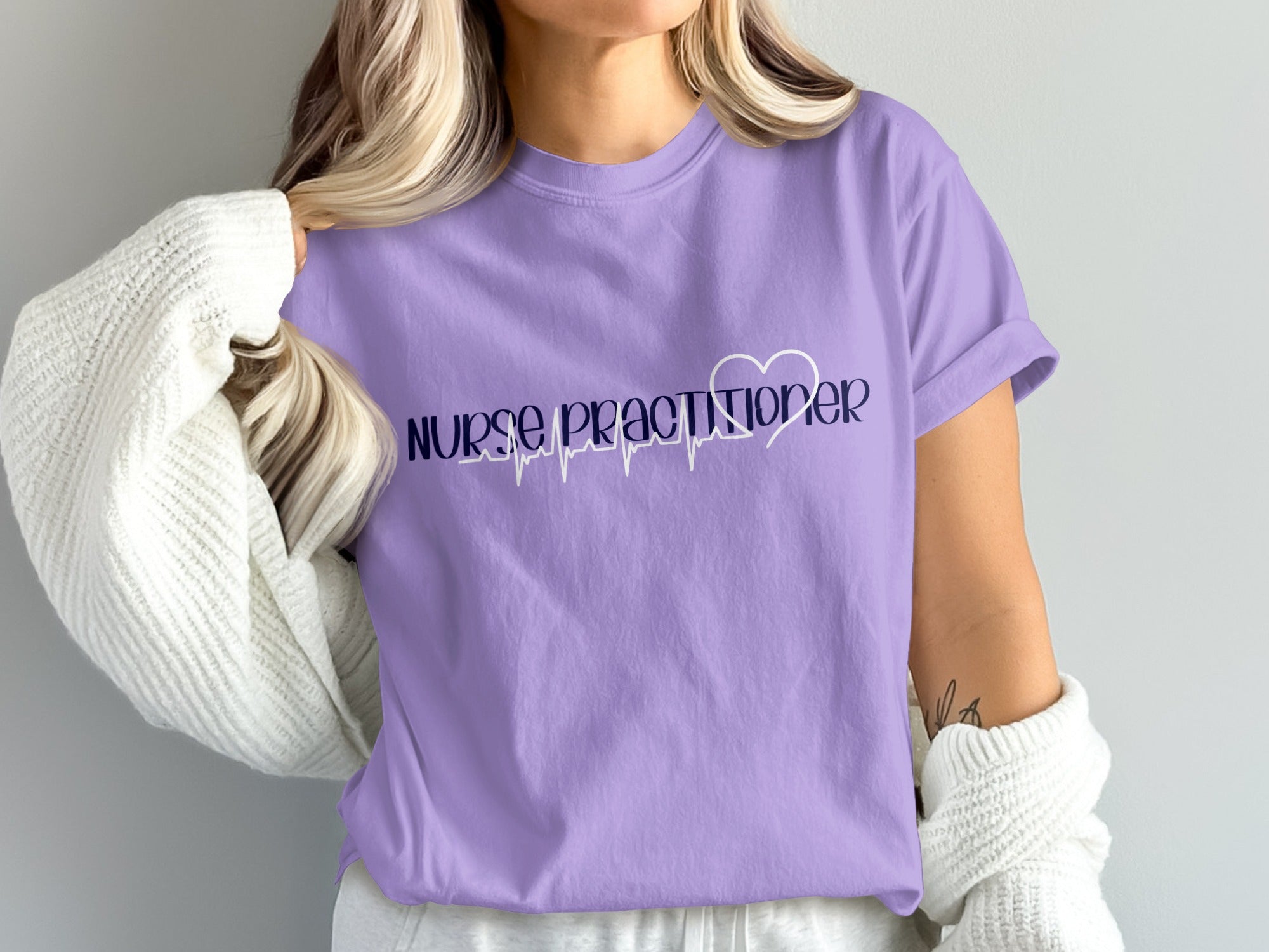 Purple t-shirt with "Nurse Practitioner" text and a heart monitor design.