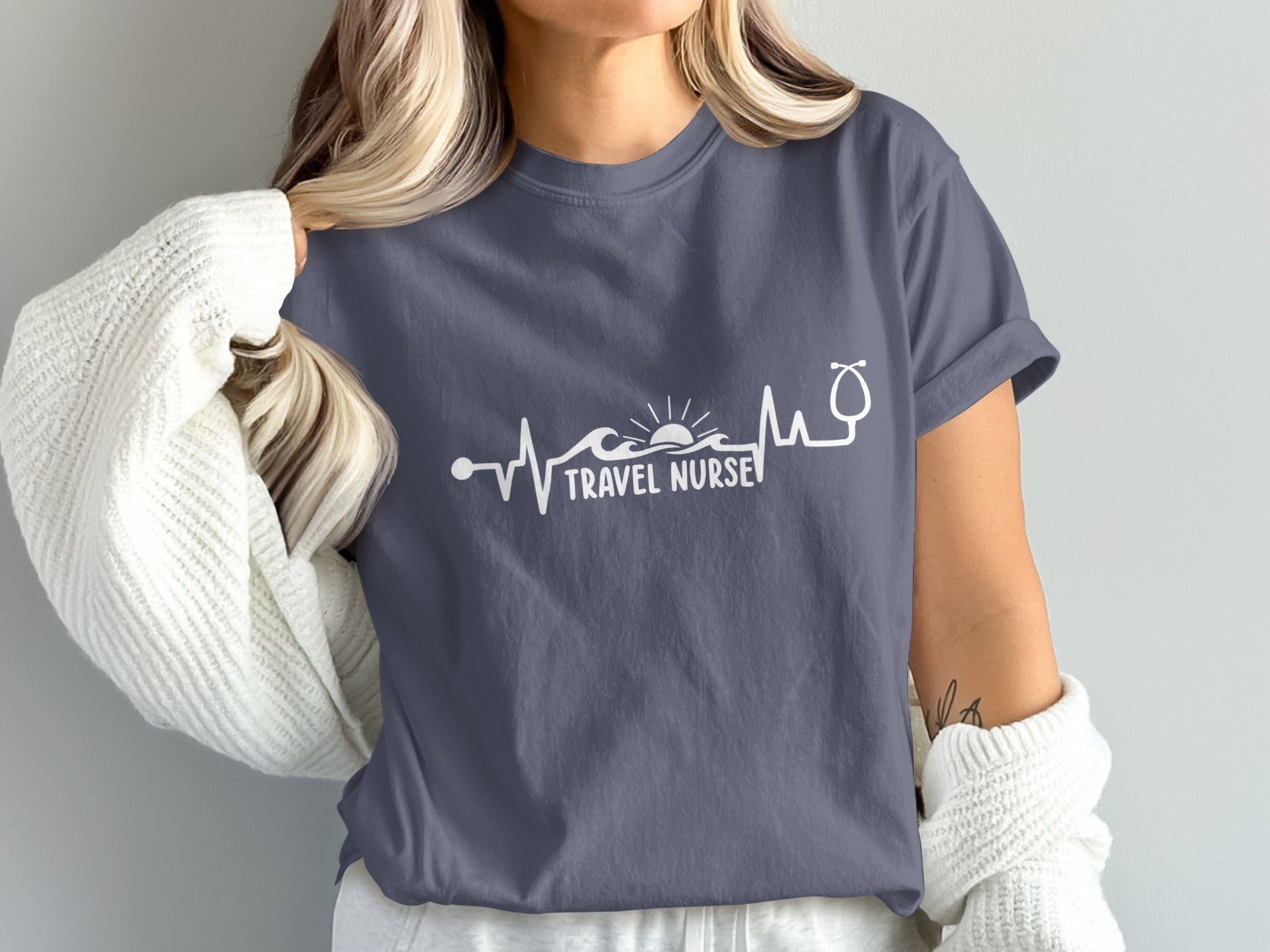 T-shirt with stethoscope and heartbeat graphic, "Travel Nurse" text.
