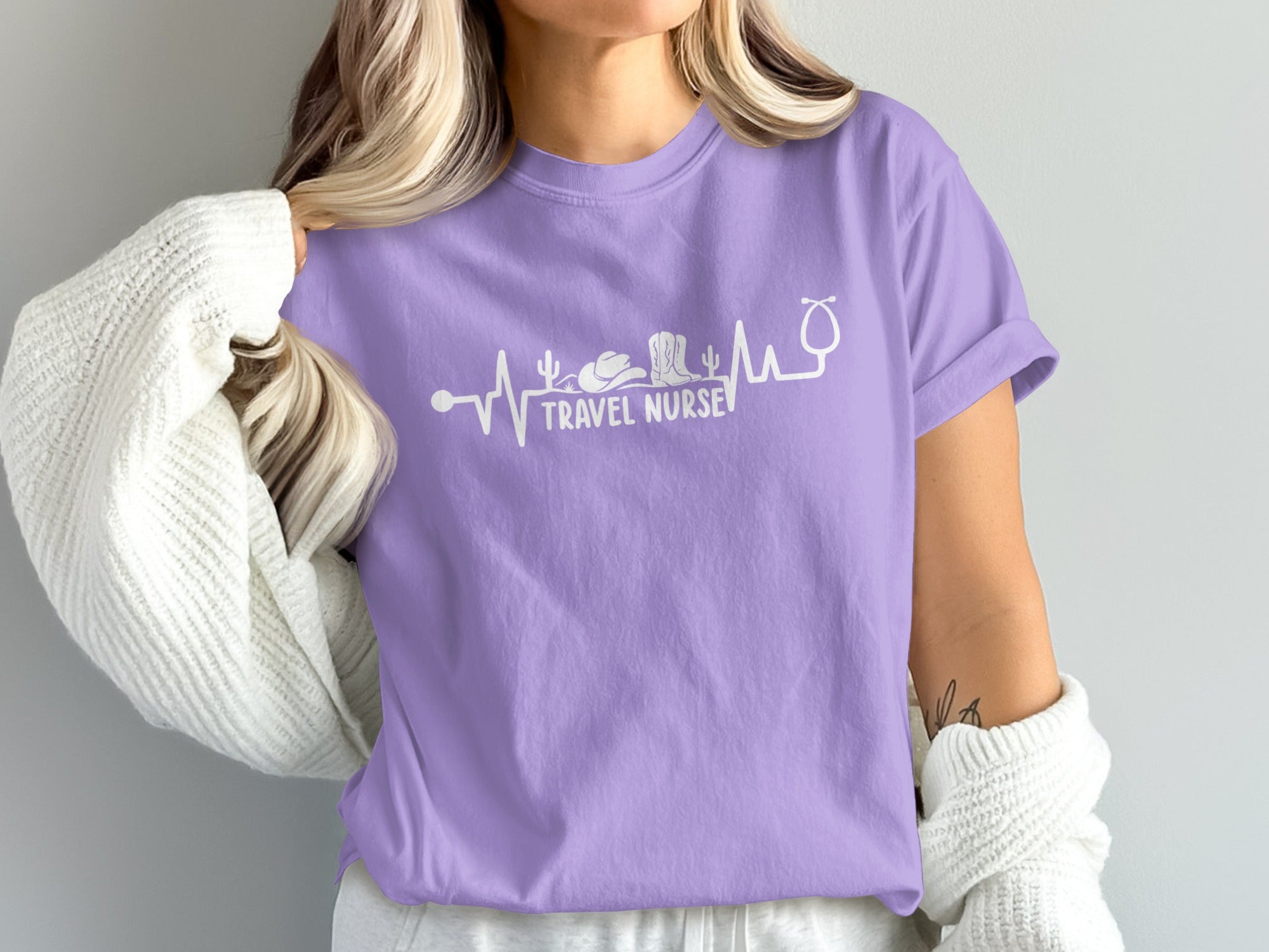 Purple t-shirt with white stethoscope and desert landscape graphic.
