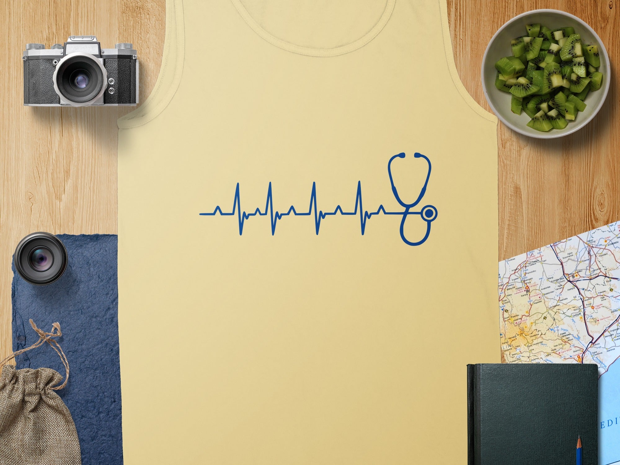 Yellow tank top with blue stethoscope heartbeat graphic and camera accessories.
