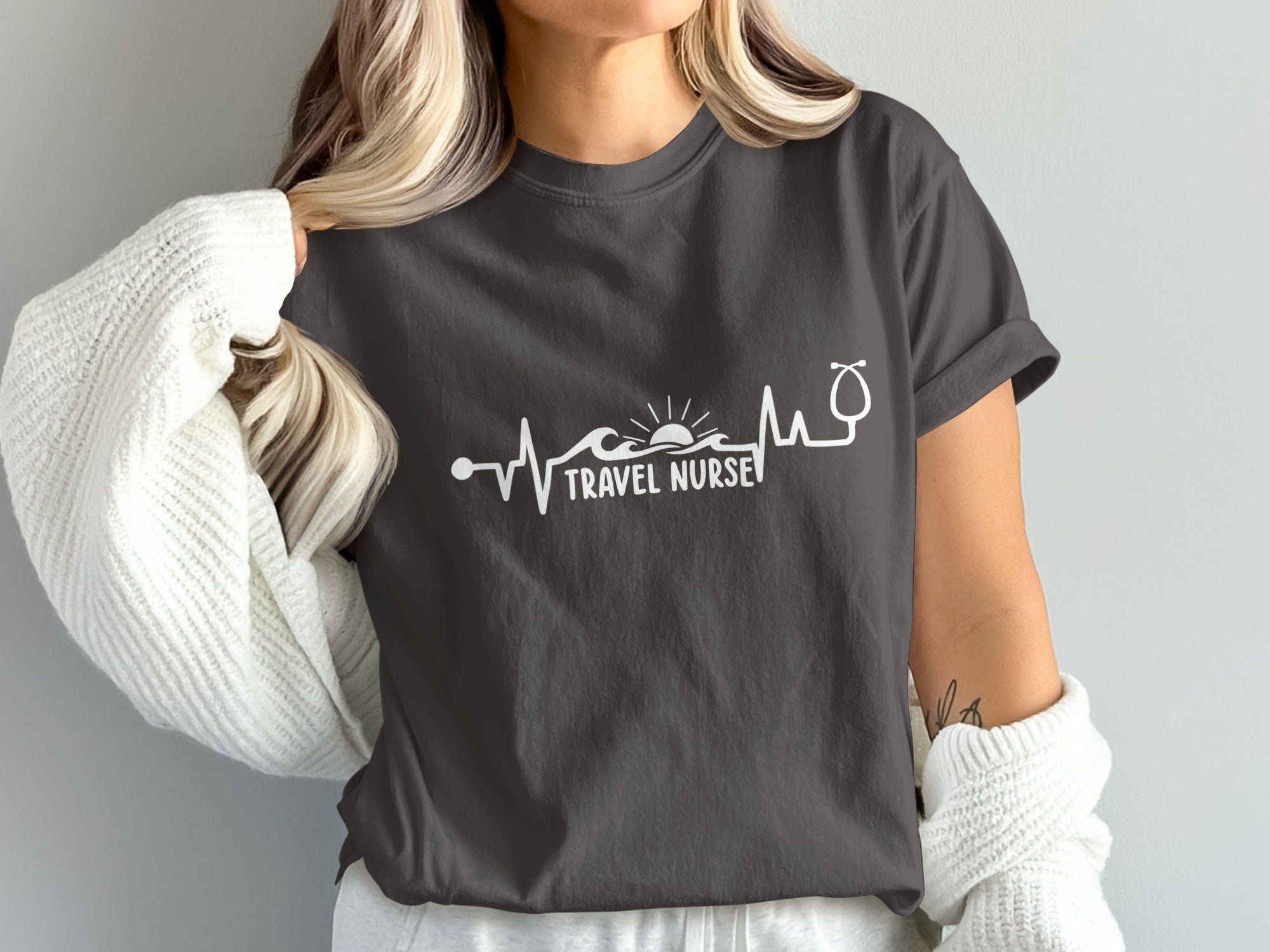 Dark grey t-shirt with "TRAVEL NURSE" and a stethoscope heartbeat graphic.