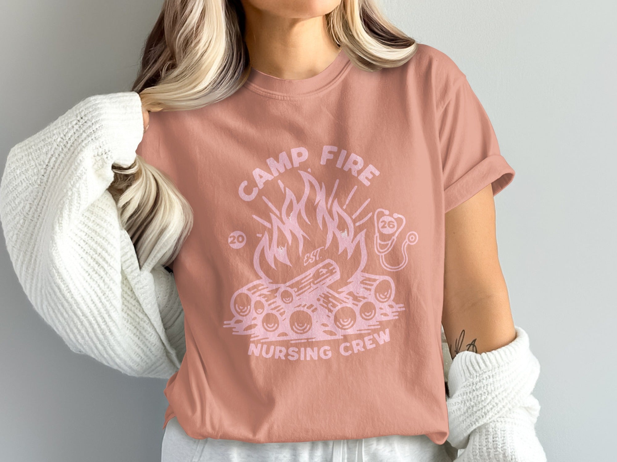Pink t-shirt with campfire and "Camp Fire Nursing Crew" text.