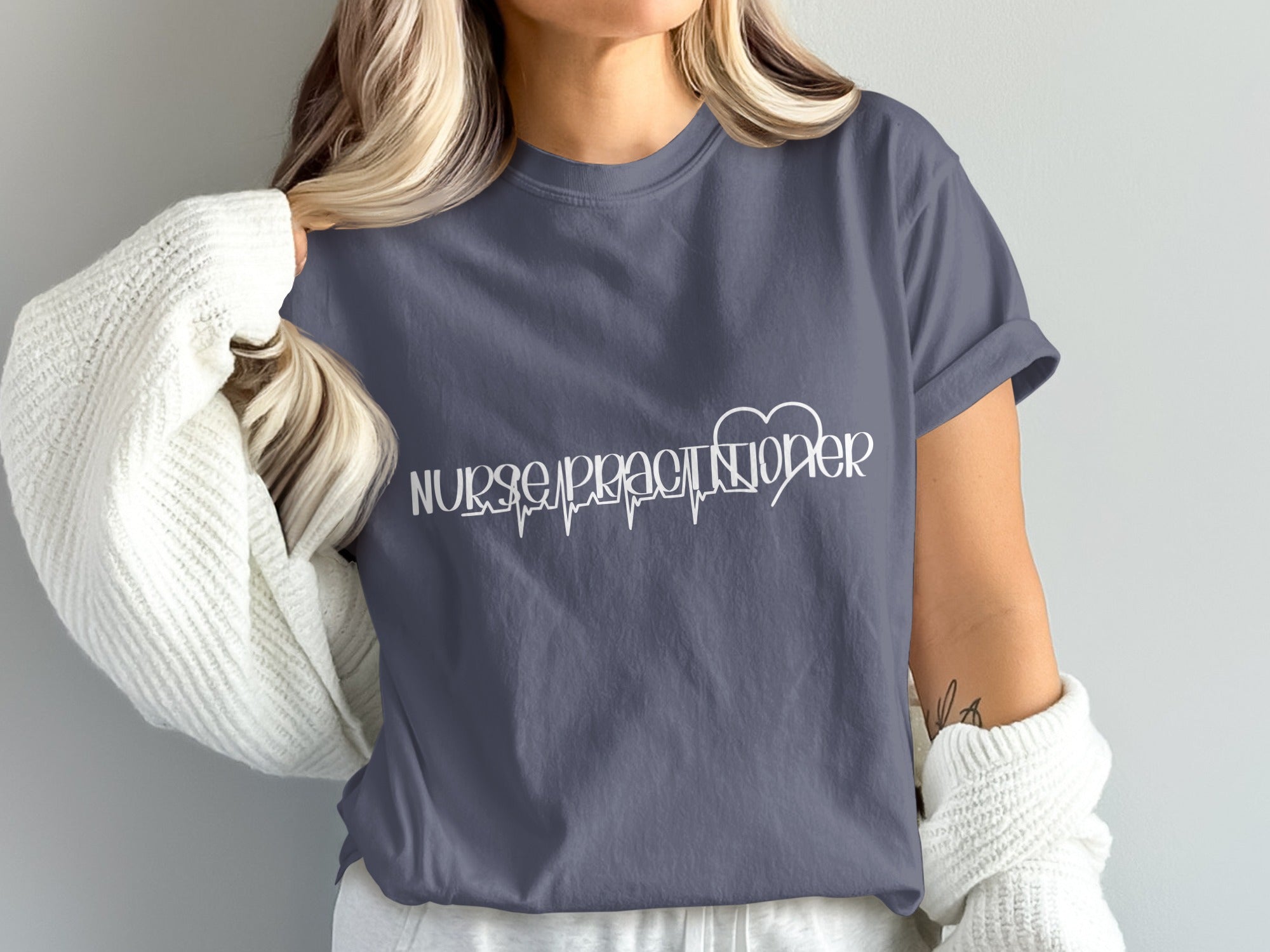 Dark grey t-shirt with "Nurse Practitioner" in white text over a heartbeat graphic.