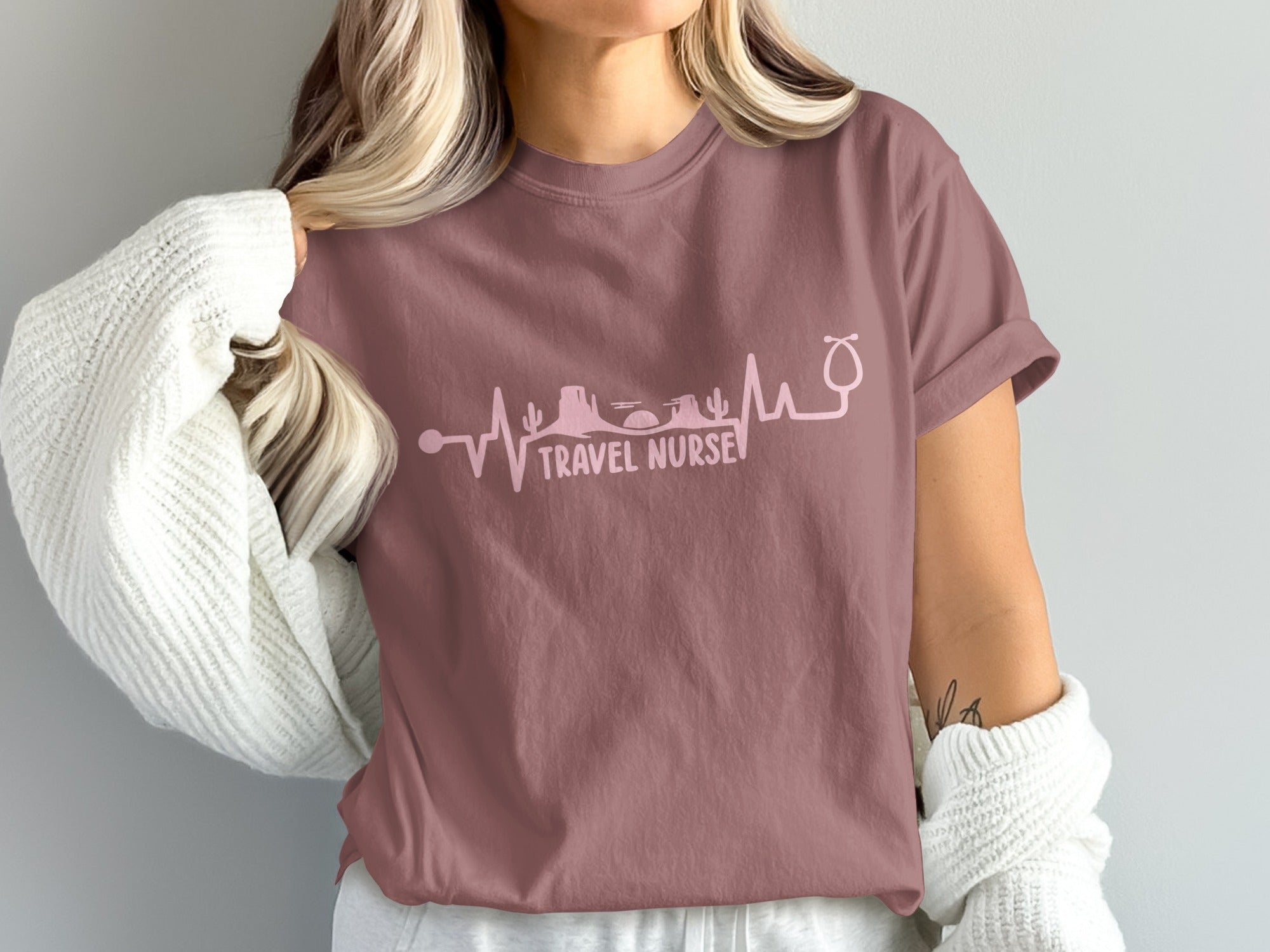 Mauve t-shirt with stethoscope heartbeat graphic and "TRAVEL NURSE" text.