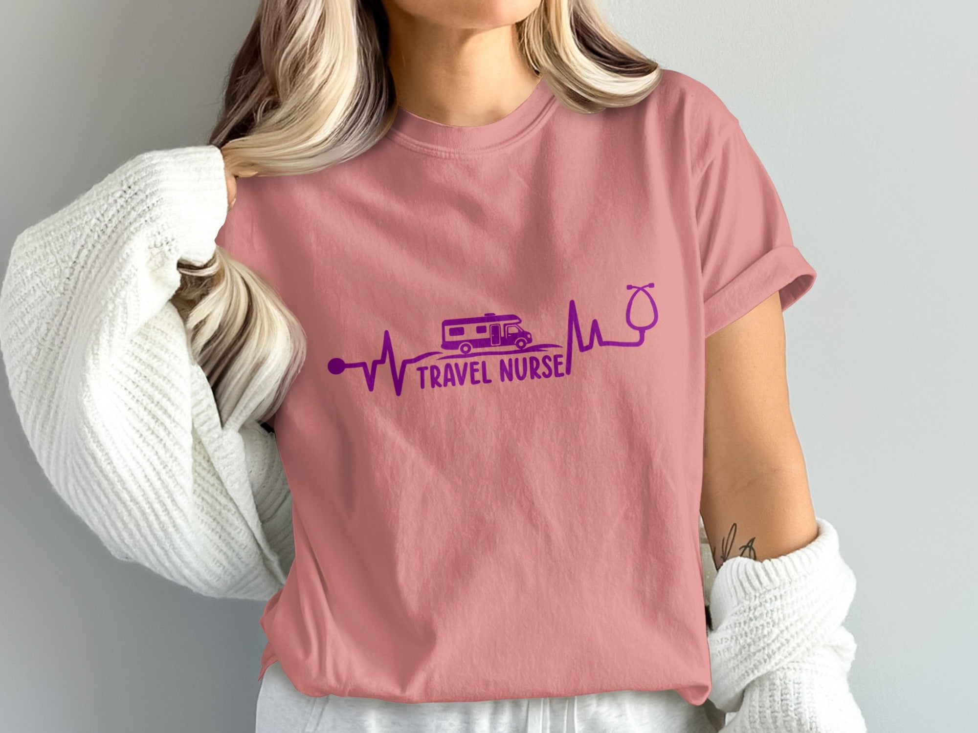 Pink t-shirt with a purple electrocardiogram design featuring a camper van and stethoscope.