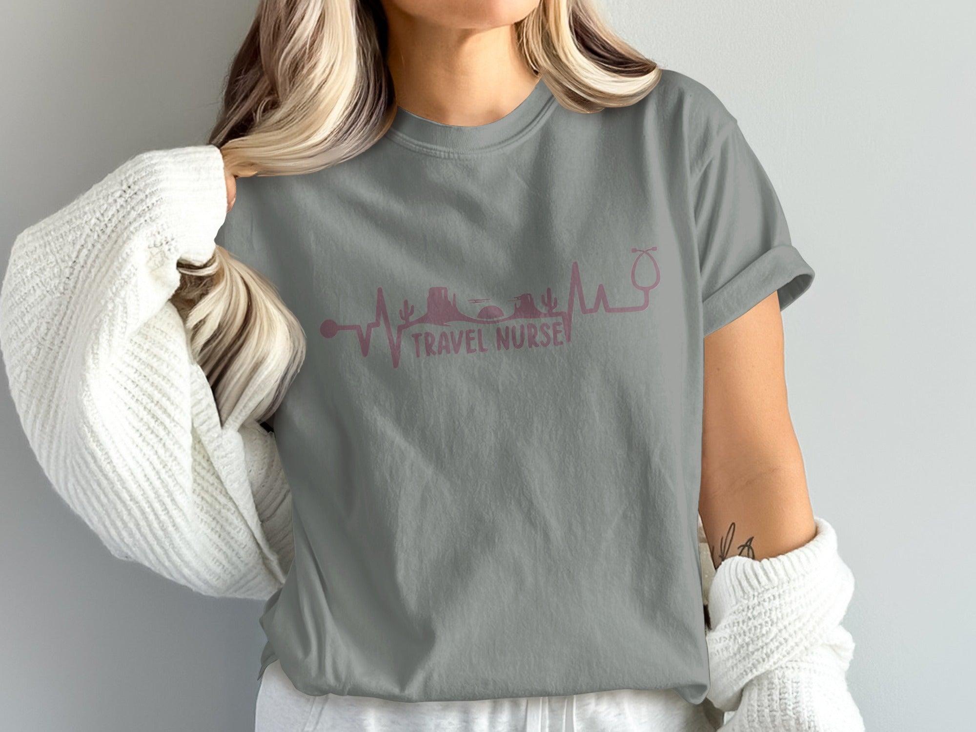 Gray t-shirt with pink travel nurse heartbeat graphic featuring stethoscope and landmarks.