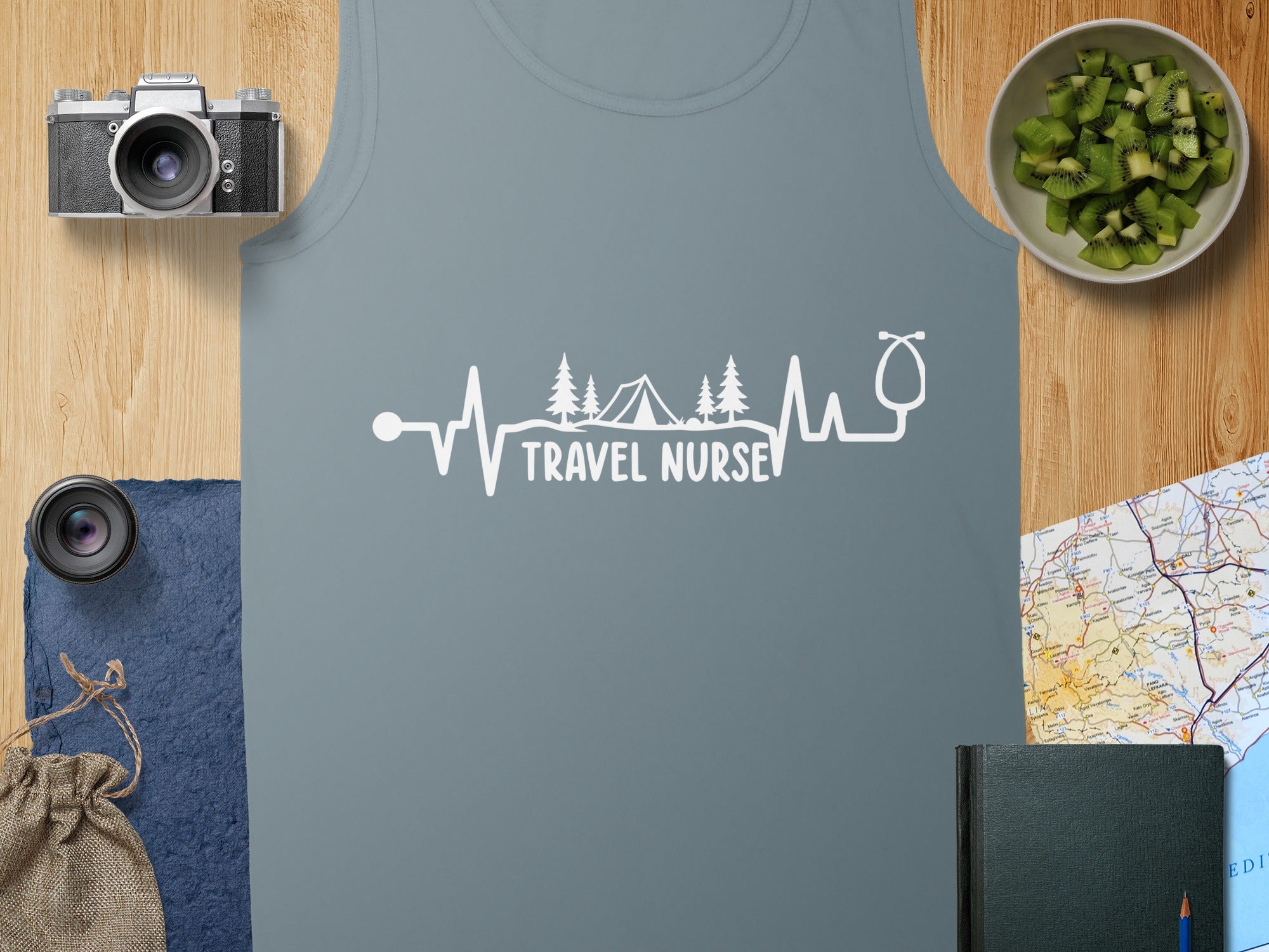 Grey tank top with "TRAVEL NURSE" text and a mountain and tent graphic.