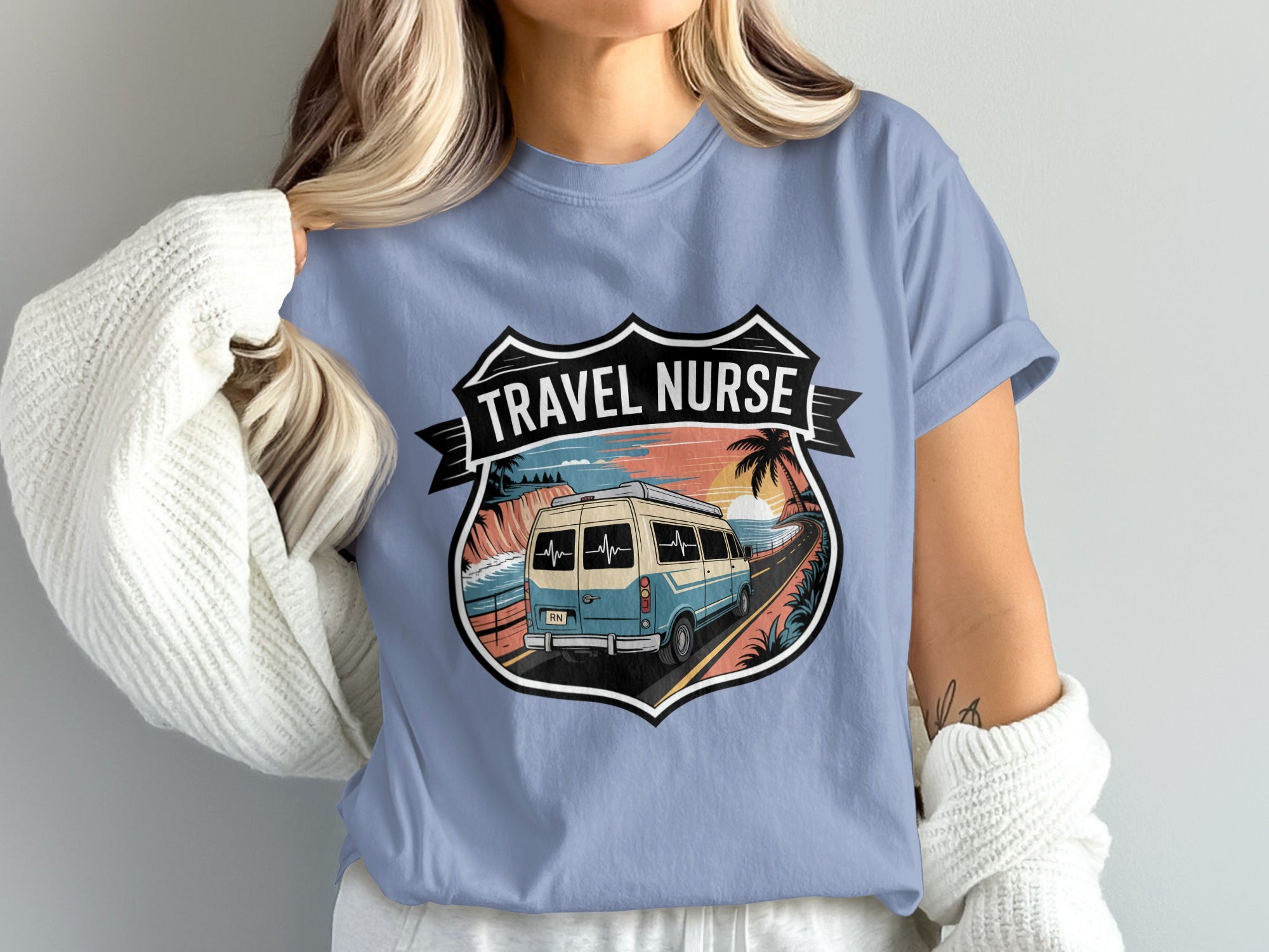Travel nurse van driving on a coastal road with palm trees and mountains.
