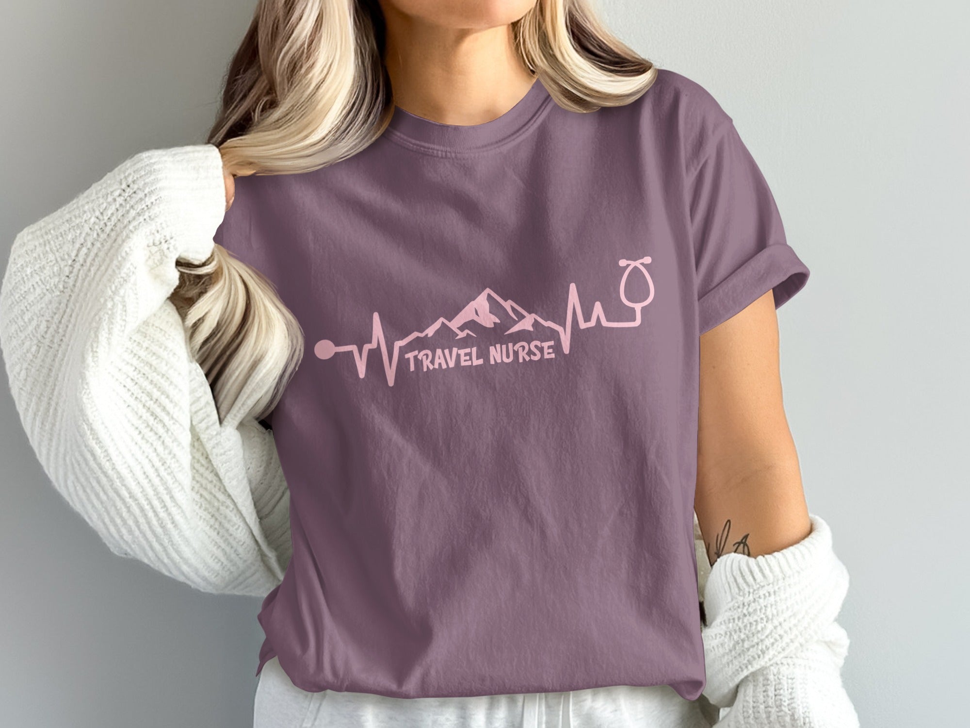 Purple t-shirt with "Travel Nurse" text and a mountain/heartbeat design.