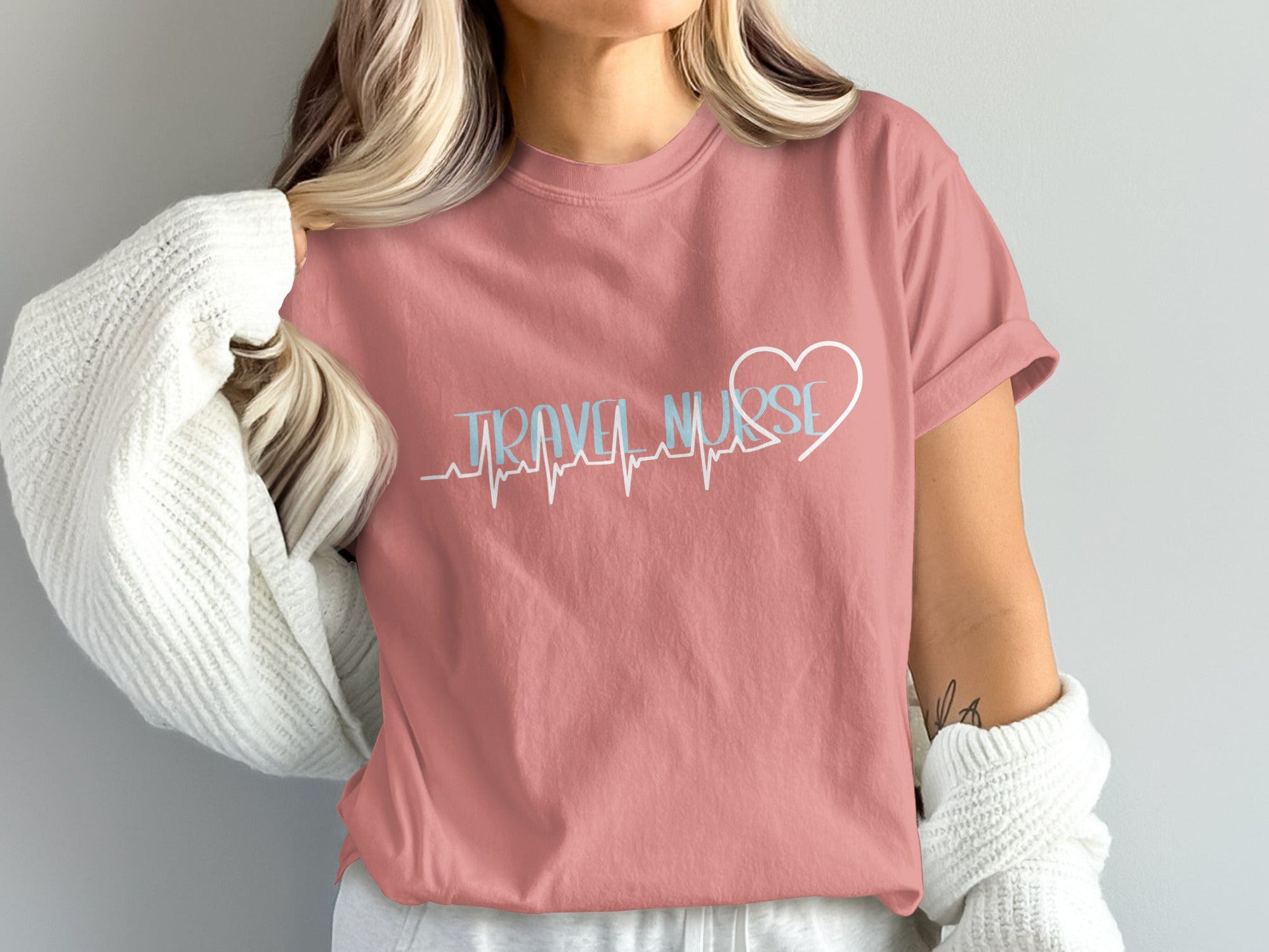 Pink t-shirt with "TRAVEL NURSE" text and heart rate graphic.