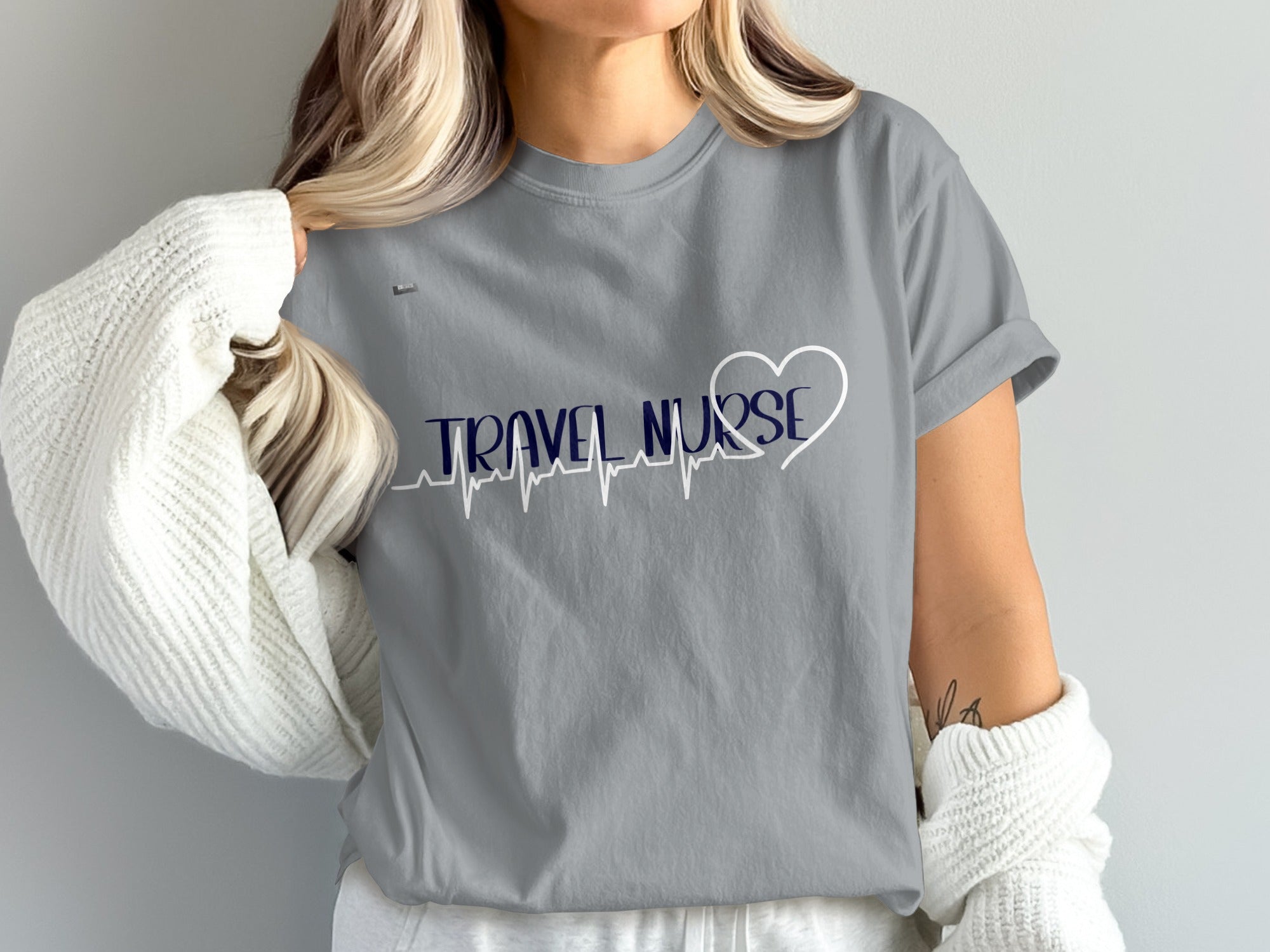 Grey t-shirt with "TRAVEL NURSE" text and a heart heartbeat graphic.