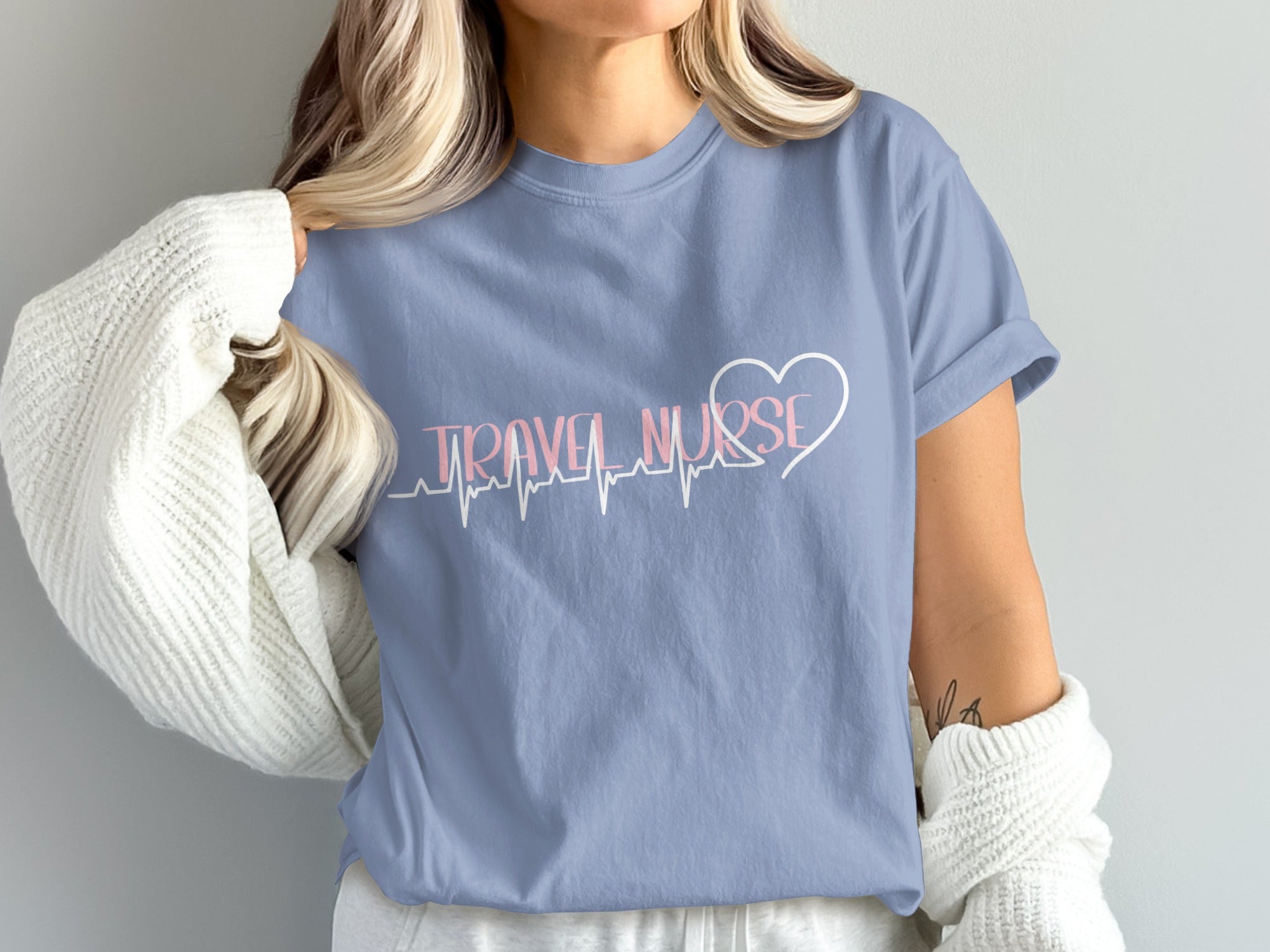 Light blue t-shirt with "Travel Nurse" and heart with EKG line design.
