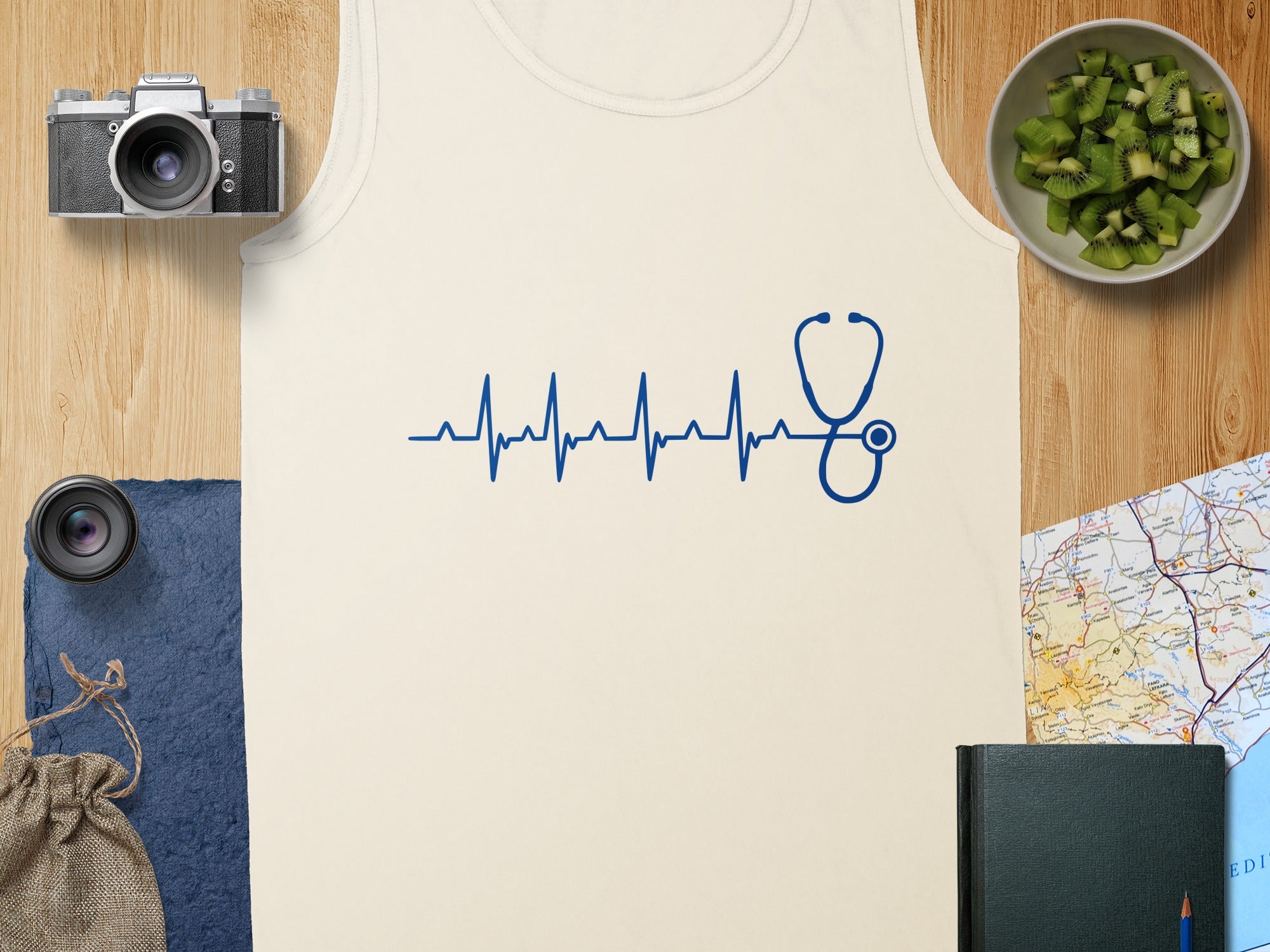 Cream tank top with blue stethoscope heartbeat graphic and overhead items.