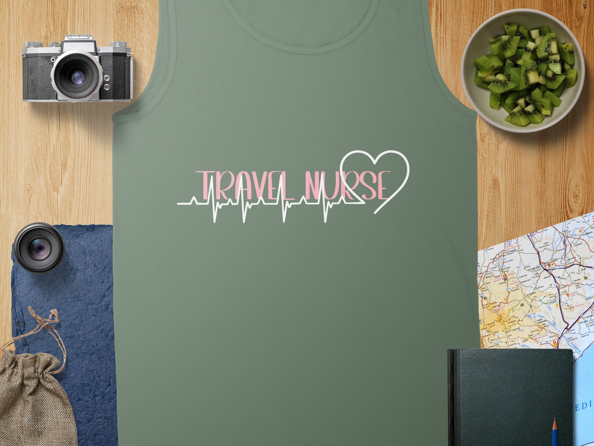 Olive green tank top with "TRAVEL NURSE" in a pink heartbeat graphic.