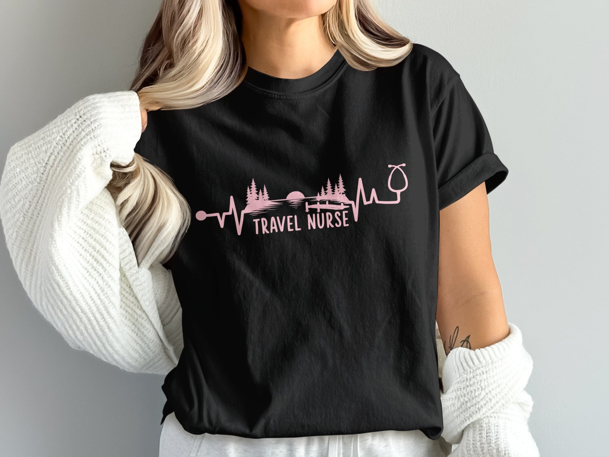 Black t-shirt with "TRAVEL NURSE" text and heartbeat landscape design.