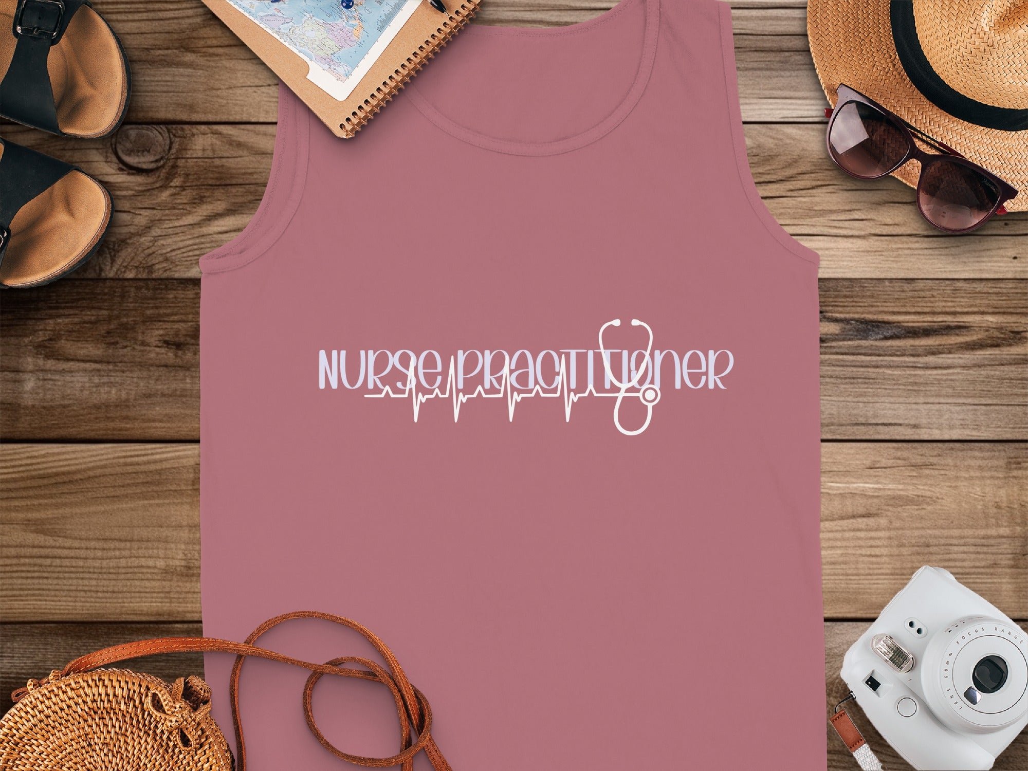 Nurse practitioner text with stethoscope heartbeat graphic on mauve tank top.