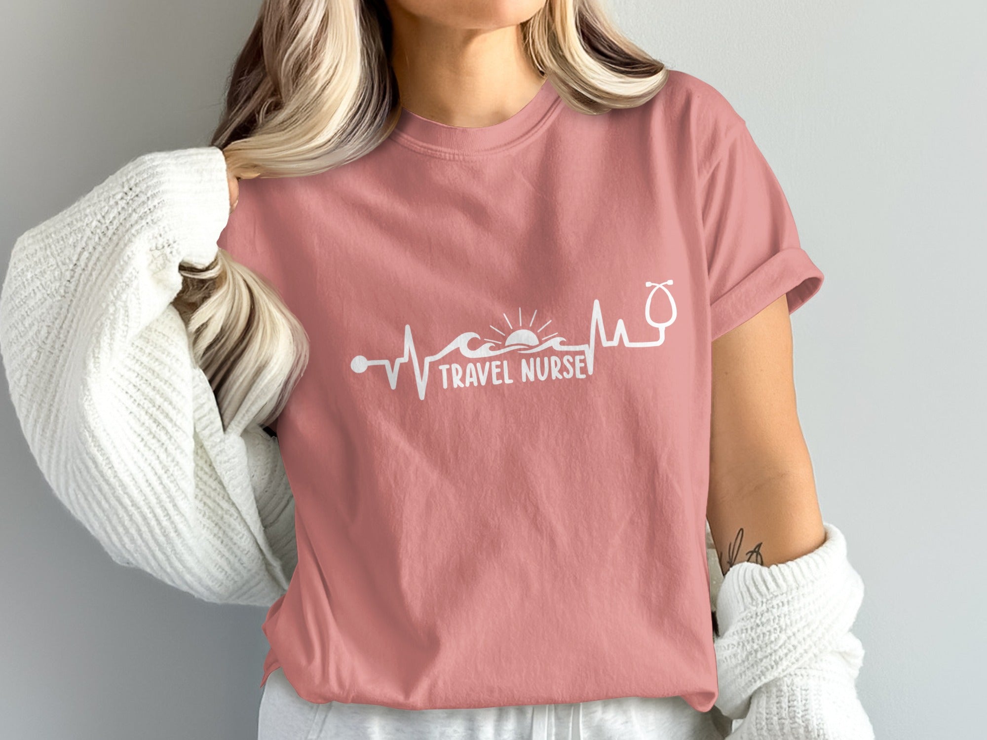 Pink t-shirt with "Travel Nurse" text and heartbeat graphic.