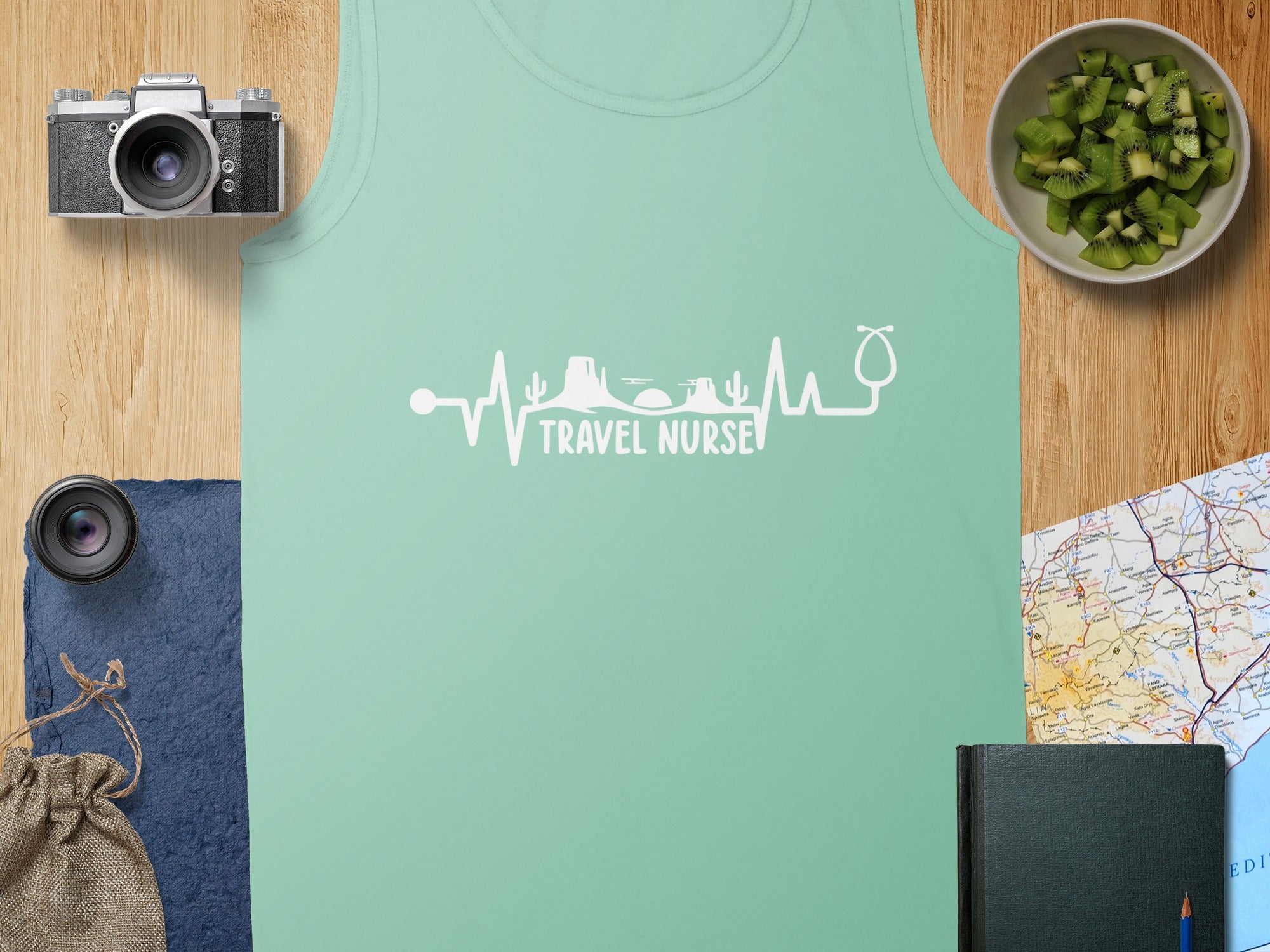 Teal tank top with white heartbeat and stethoscope graphic reading "Travel Nurse".