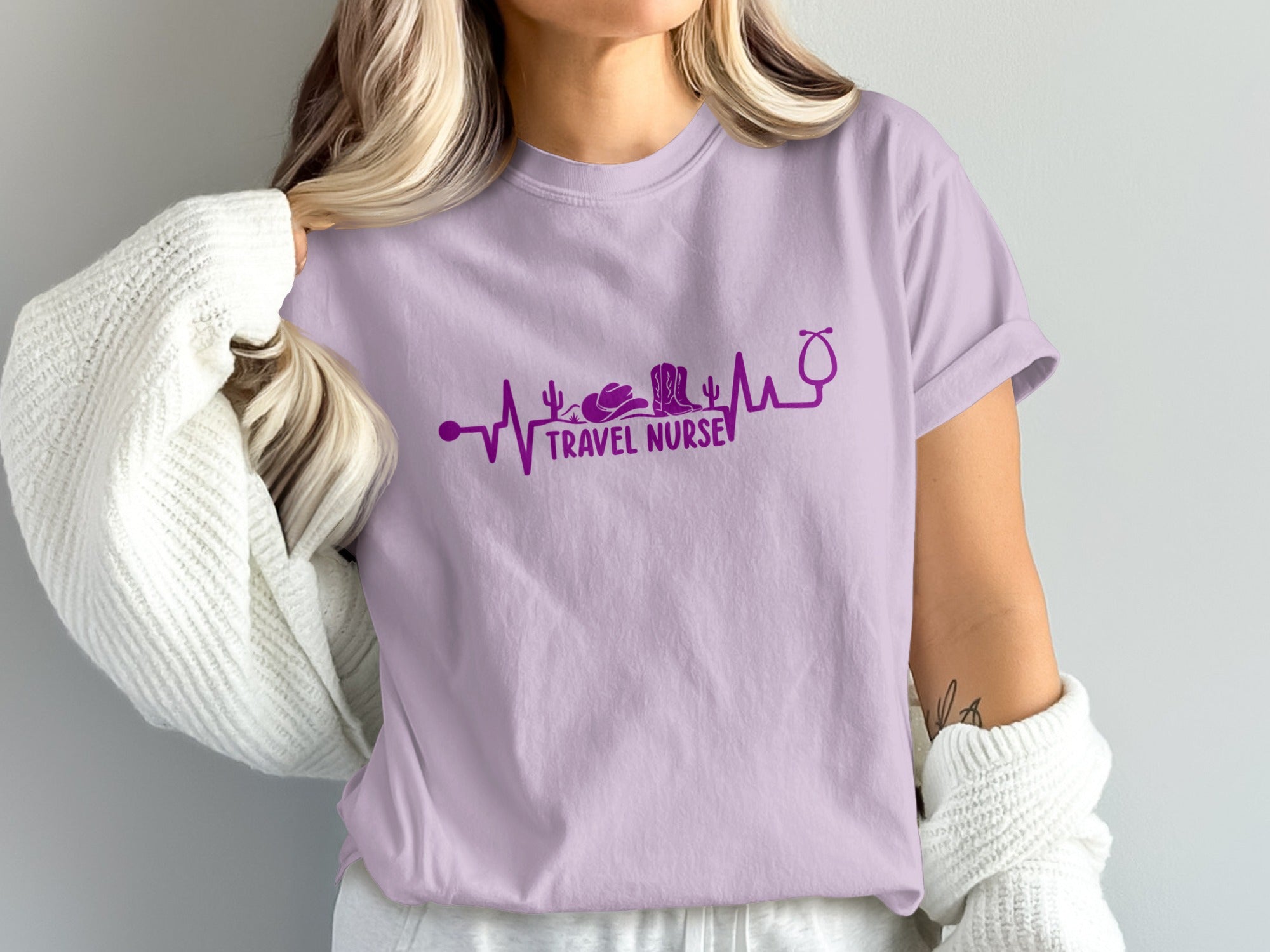 Purple t-shirt with stethoscope, cowboy boot, and cactus heartbeat design.