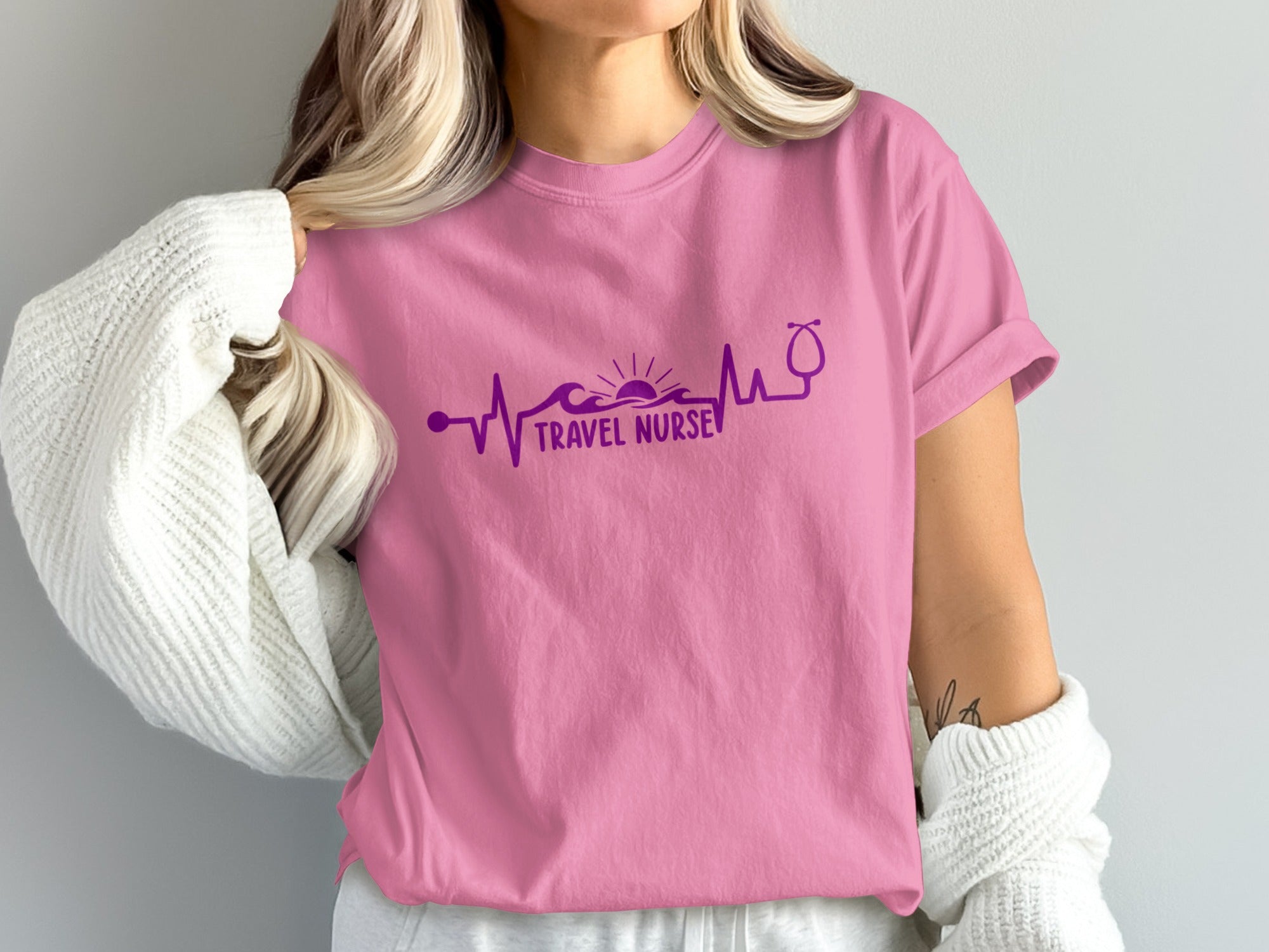 Pink t-shirt with "Travel Nurse" text and heartbeat EKG lifeline graphic.