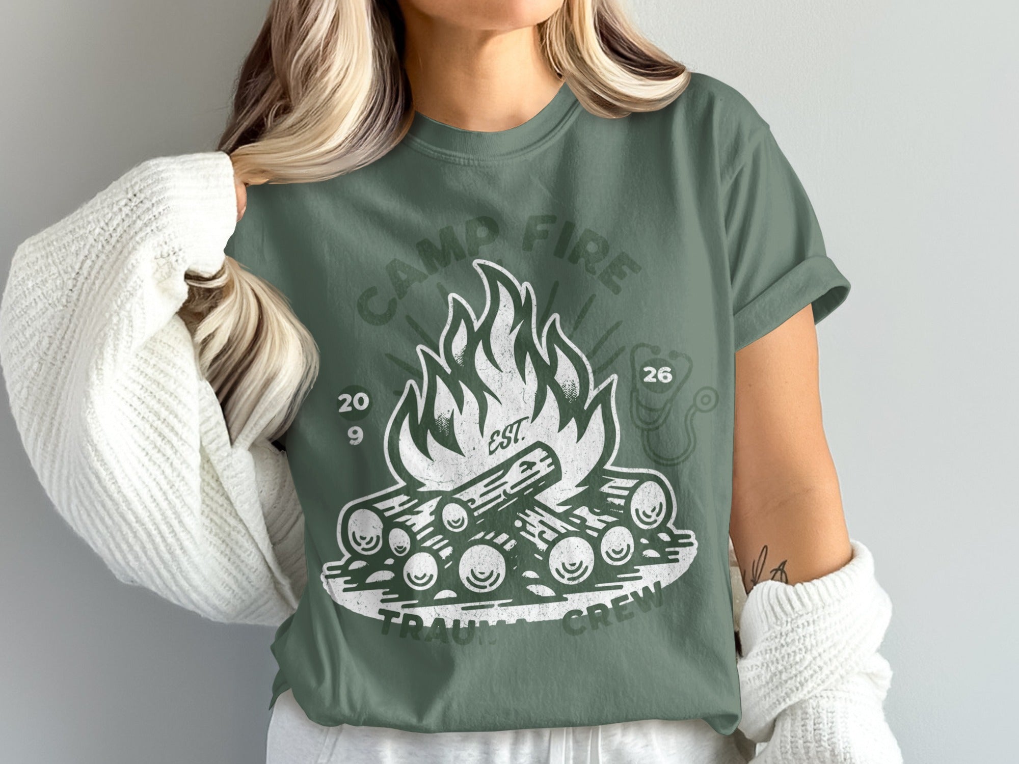 Camp Fire Trauma Crew design on a green t-shirt.